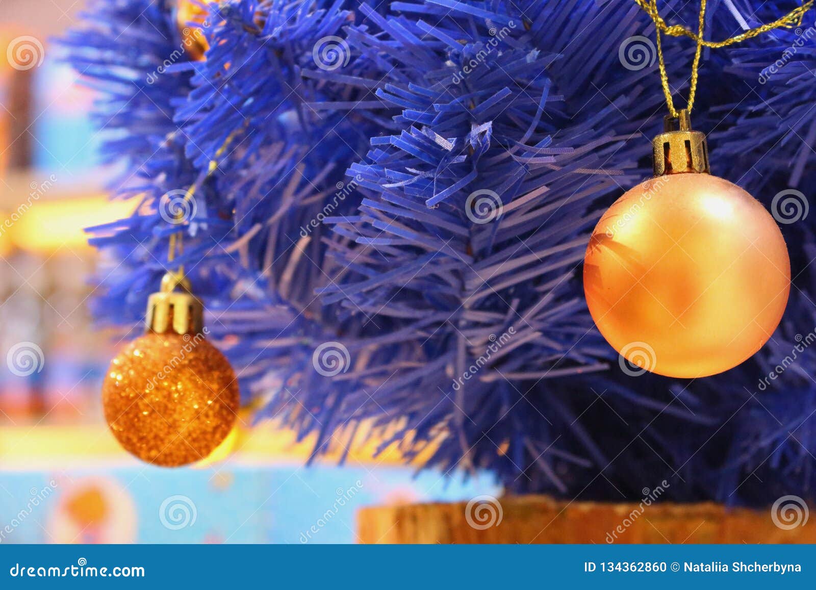 Blue Christmas Tree with Yellow Bulbs. Blue Artificial Pine Tree Branch ...