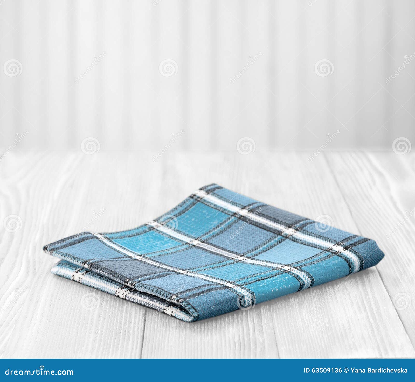 blue cloth napking on white wooden background with empty space
