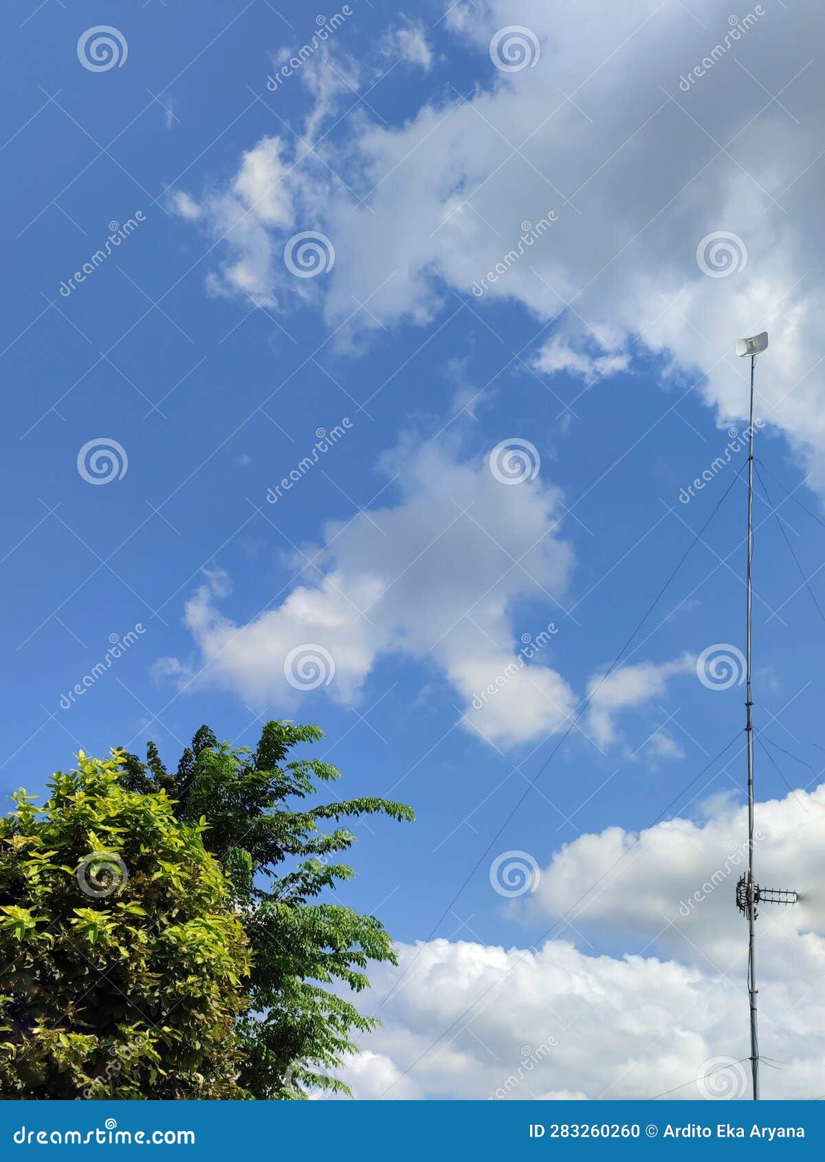 Blue Cloud View with Complementary Trees and Wifi Tower Stock Photo