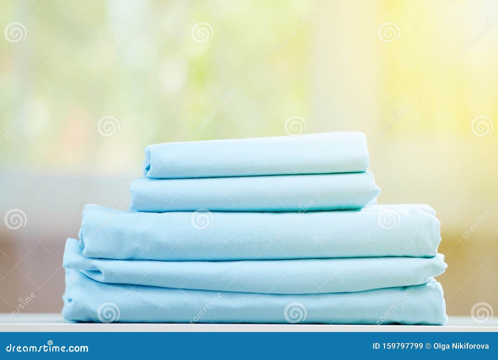 Blue Colored Bedding on a Blurred Background. Stack of Folded New