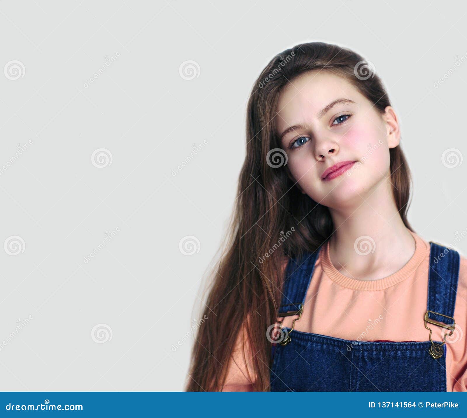 Blue Eyed Shy Girl With Flowing Hair Studio Model Shot Stock Photo