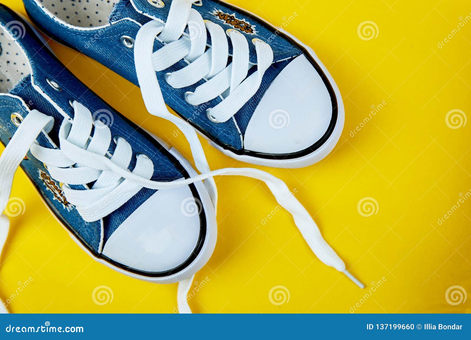 Blue Female or Male Sneakers on Yellow Paper Background Stock Photo ...