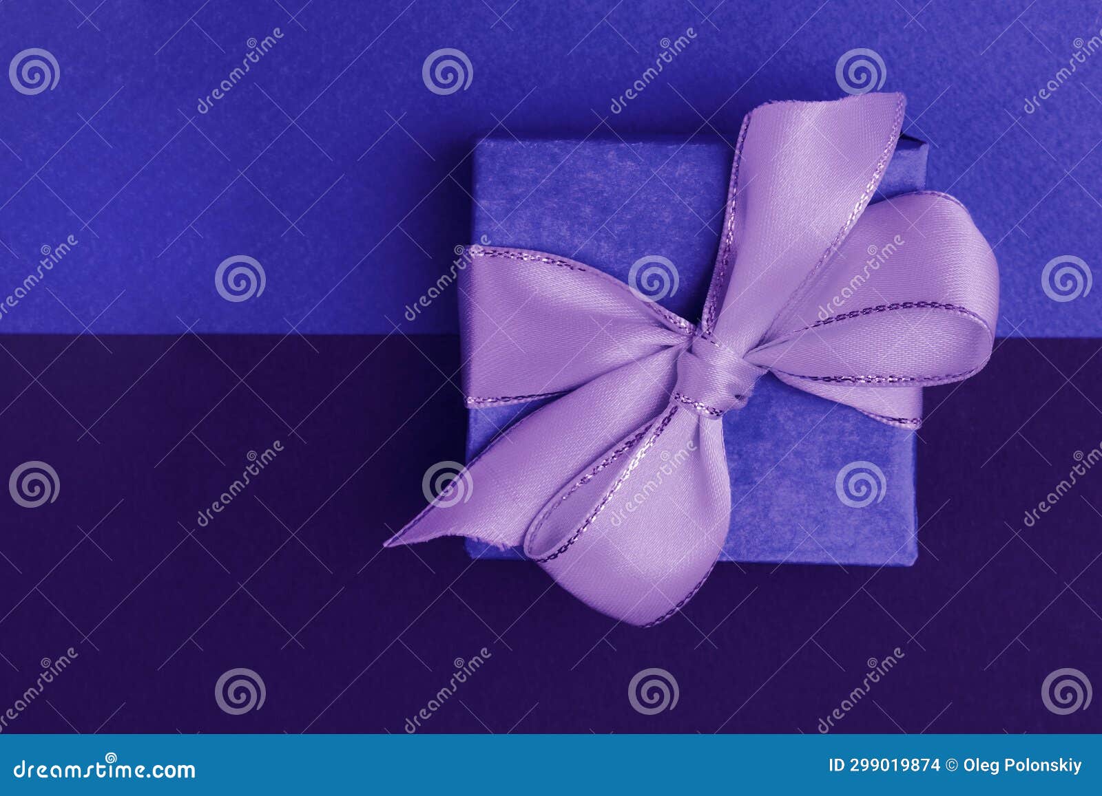 Blue Gift Box with a Purple Bow on a Twotone Background, Blue and