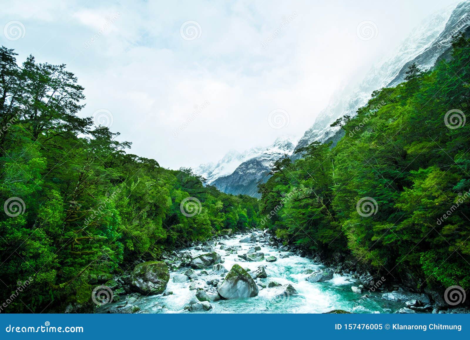 a blue glacier river among the green nature. i