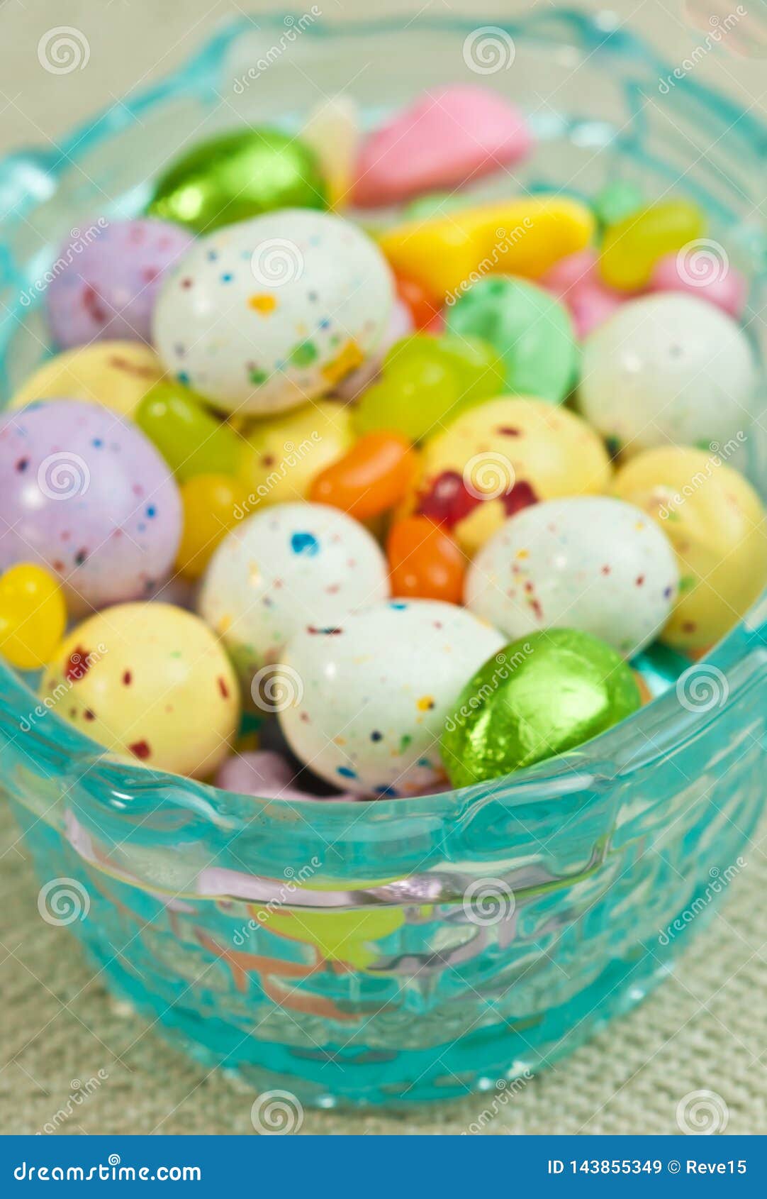 A Blue, Glass Easter Basket, Filled with Candy Easter Eggs Stock Image