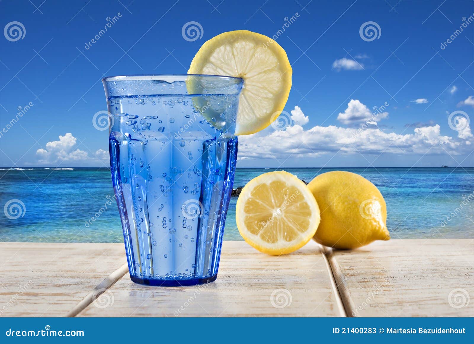 A Glass Of Sparkling Water Cocktail With Sliced Lemon, Cherry And Berry