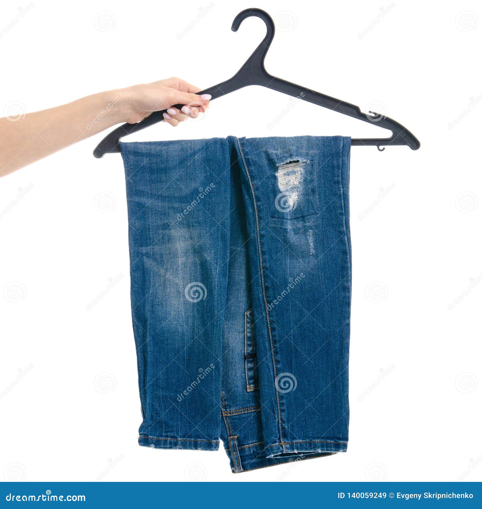 Blue Jeans on Hanger in Hand Stock Image - Image of jeans, elegant ...