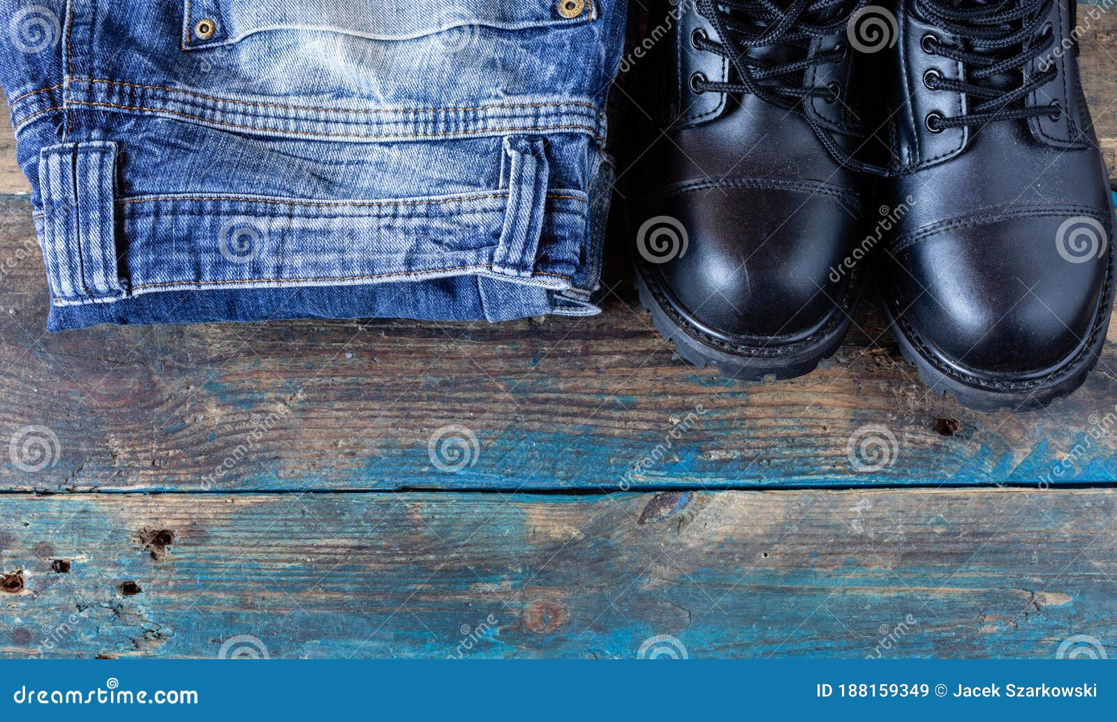 Blue Jeans and Leather Shoes. Folded Pants on Old Boards. Black Work ...