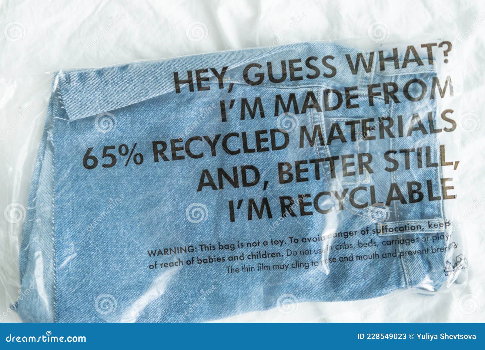 Blue Jeans in Plastic Bag with Tag Recycled Materials and Recyclable