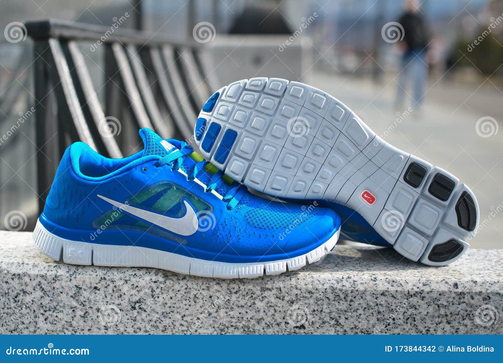 Blue Nike Free 5.0 Running Shoes on Grey Urban Background. Krasnoyarsk, Russia - April 16, 2015 Editorial Photography - Image of footwear, product: 173844342