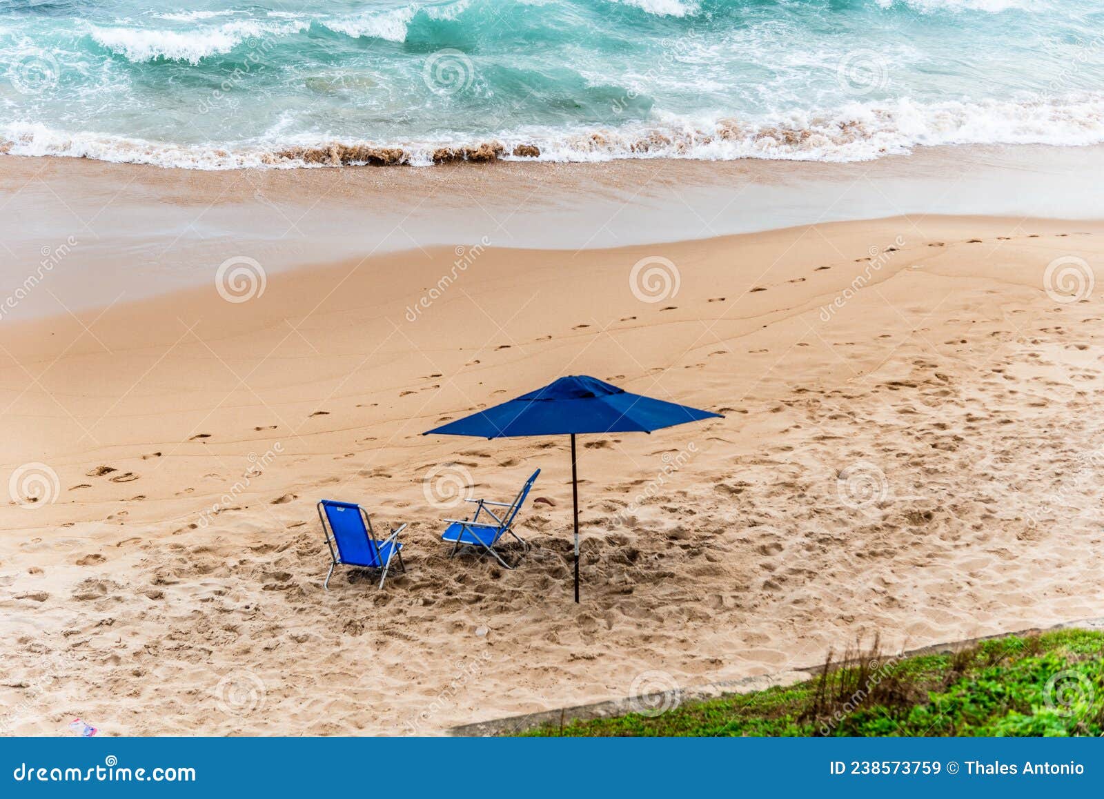 blue parasol on the sand of paciencia beach in the rio vermelho