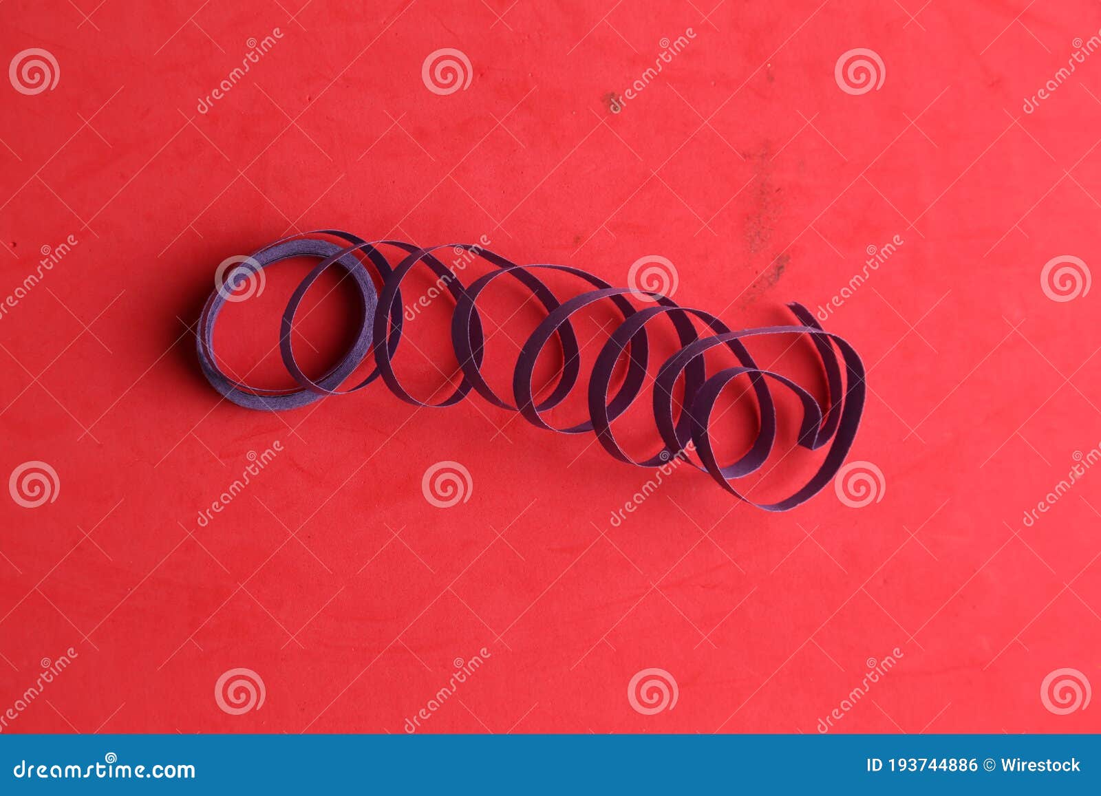 Blue Party Streamers Isolated on a Red Background Stock Photo Image