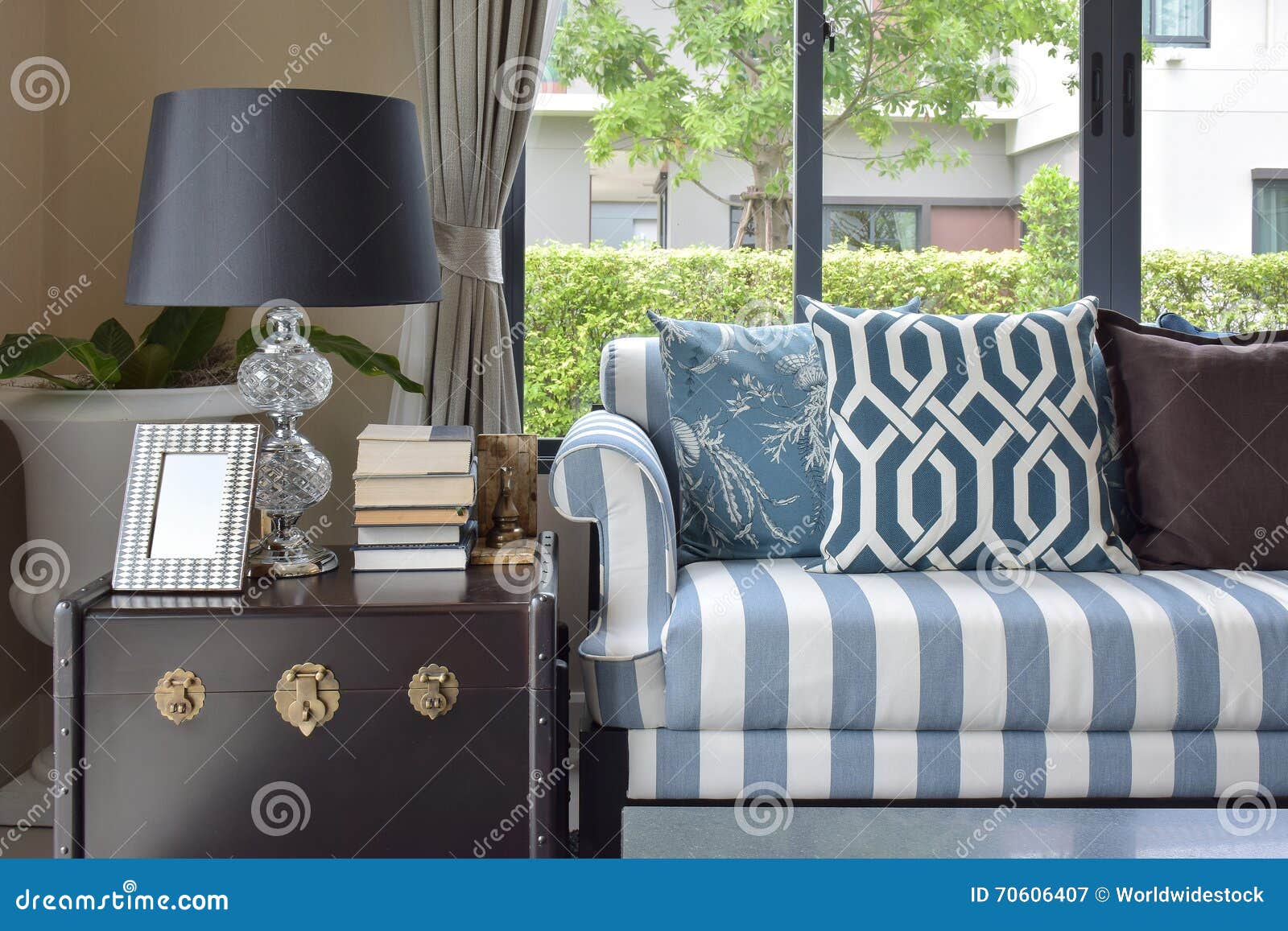 Blue Pattern Pillows on Striped Sofa with Black Lamp Stock Image