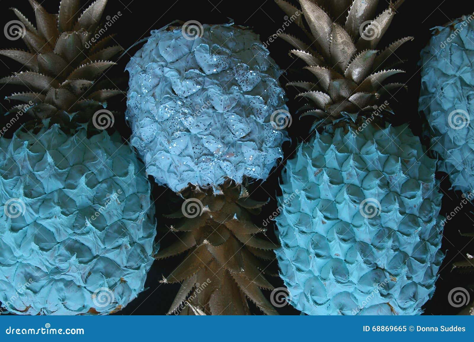 Blue Pineapple with Gold Leaves on Black Background Stock Image