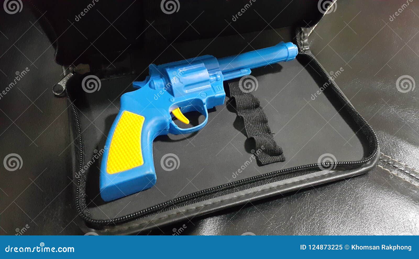 Blue Plastic Gun a Yellow Handle and Trigger is Placed Stock Image