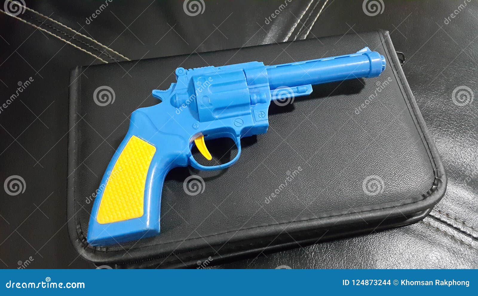 Blue Plastic Gun a Yellow Handle and Trigger is Placed Stock Photo
