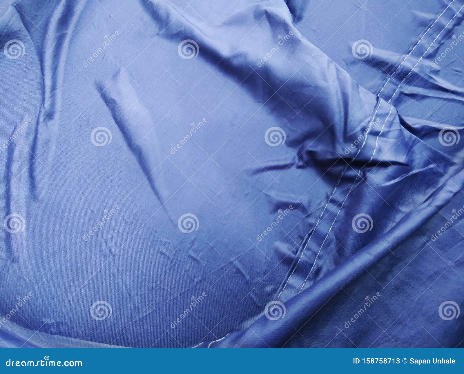 The Blue Plastic Sheet on the Car for Dust and Rain Protection. Stock