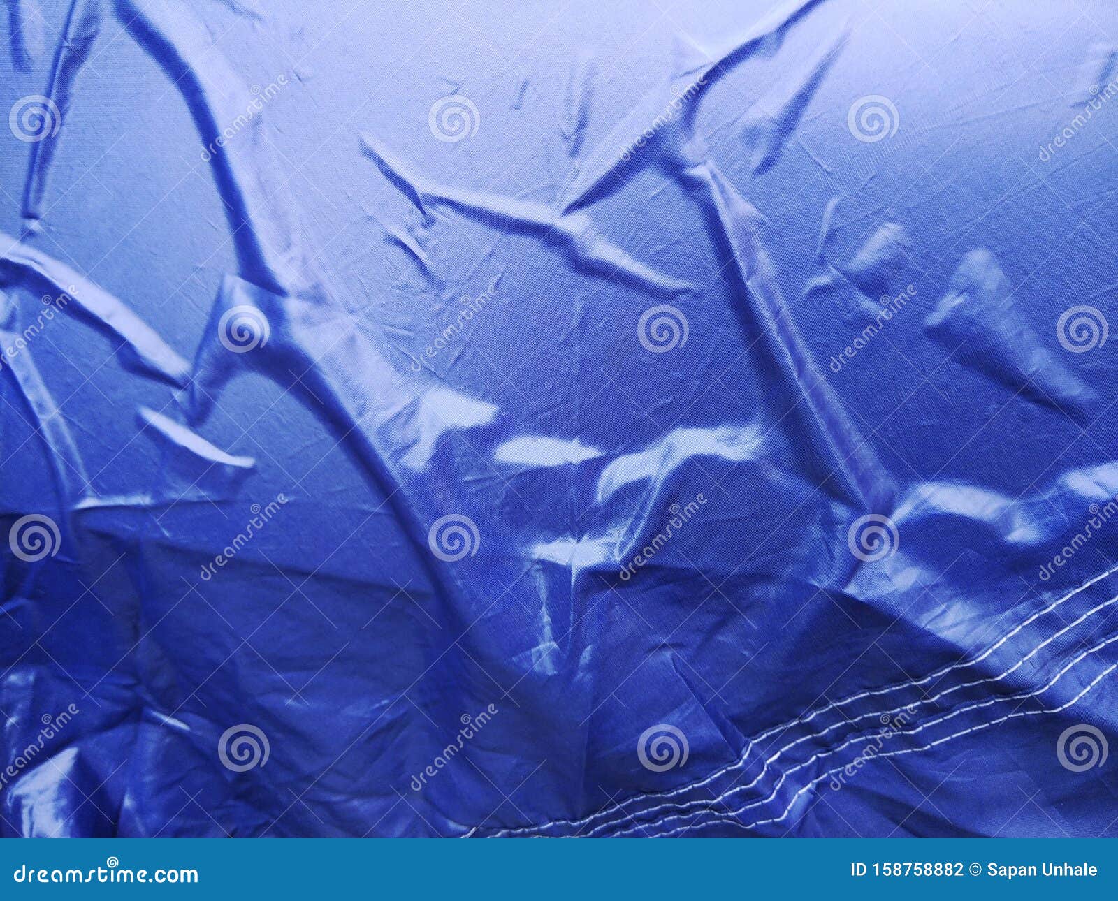 The Blue Plastic Sheet on the Car for Dust and Rain Protection. Stock