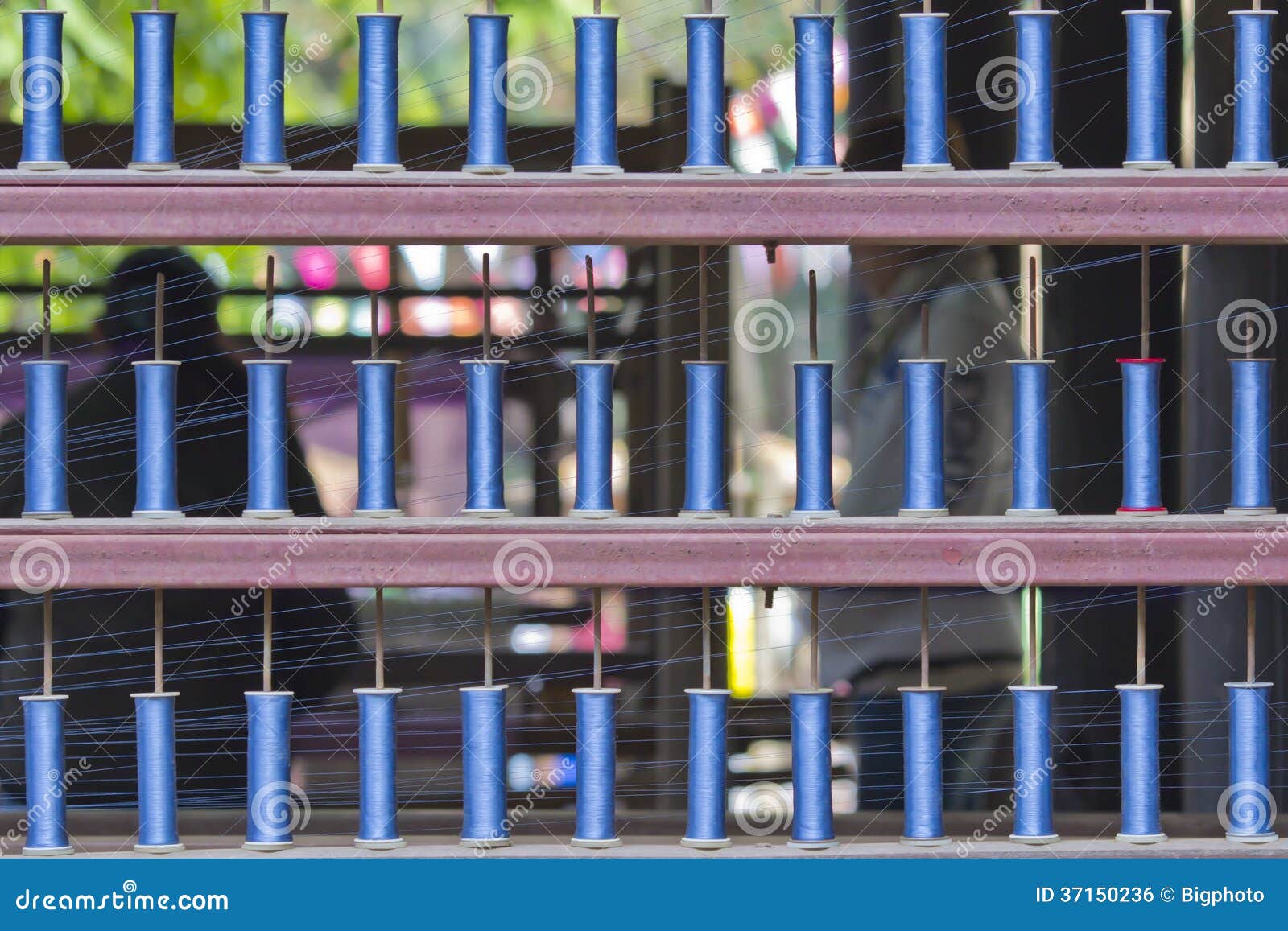 Blue Reels of Textile Yarn Thread at Manufacturing Machine. Stock Photo