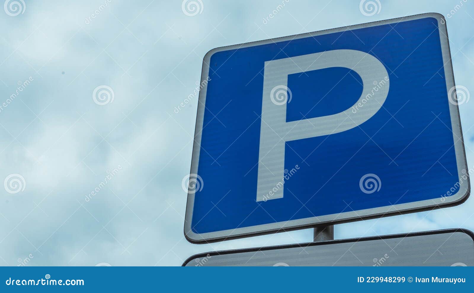 Blue Road Sign with Letter P on Rectangular Plate Isolated Against a