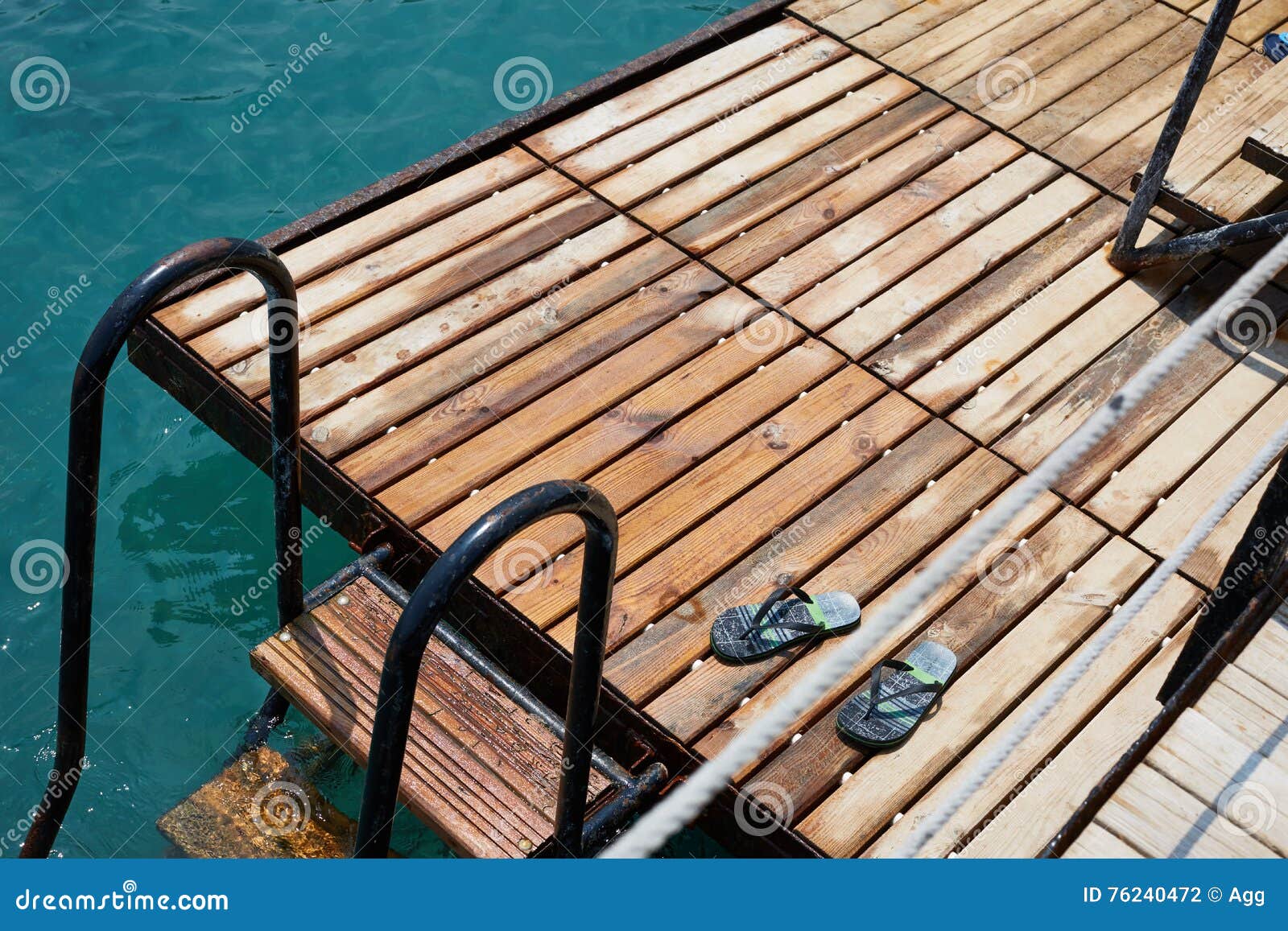 blue step-ins on the wooden sea pier stairs