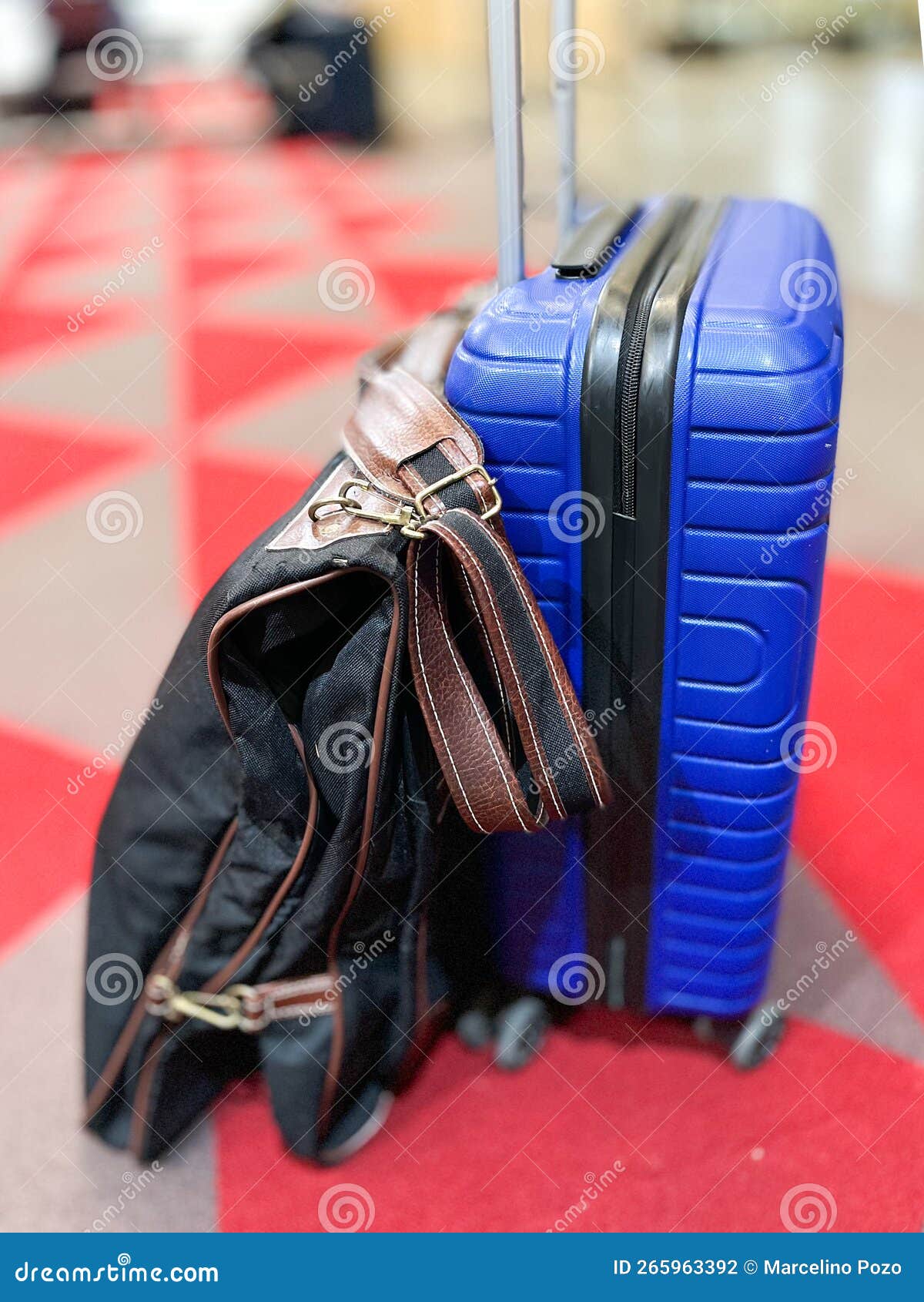 Blue Suitcase and Garment Rack on the Platform Floor of a Modern Long