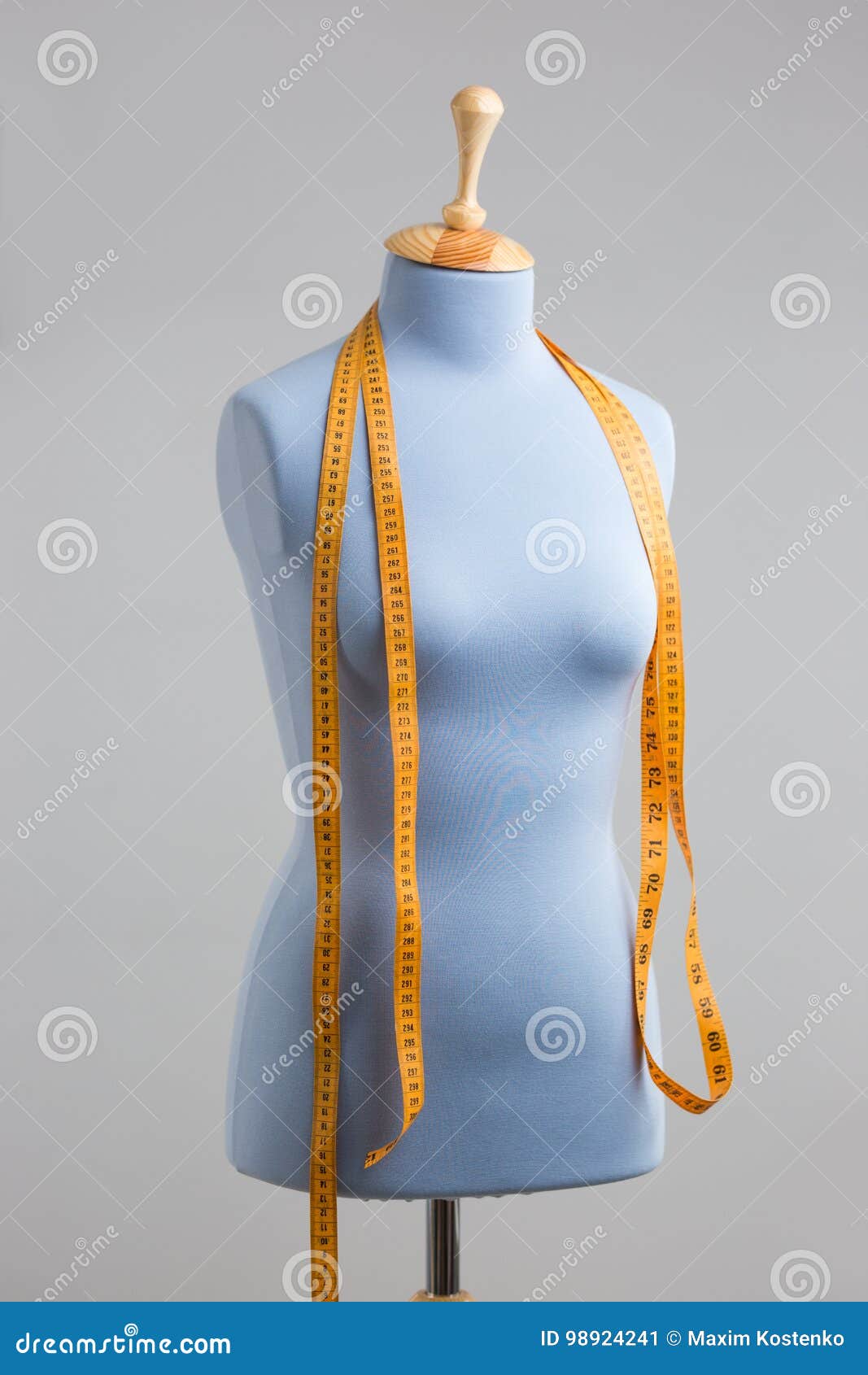 Blue Tailor Dummy with Measuring Tape Alongside the Wall. Stock Image