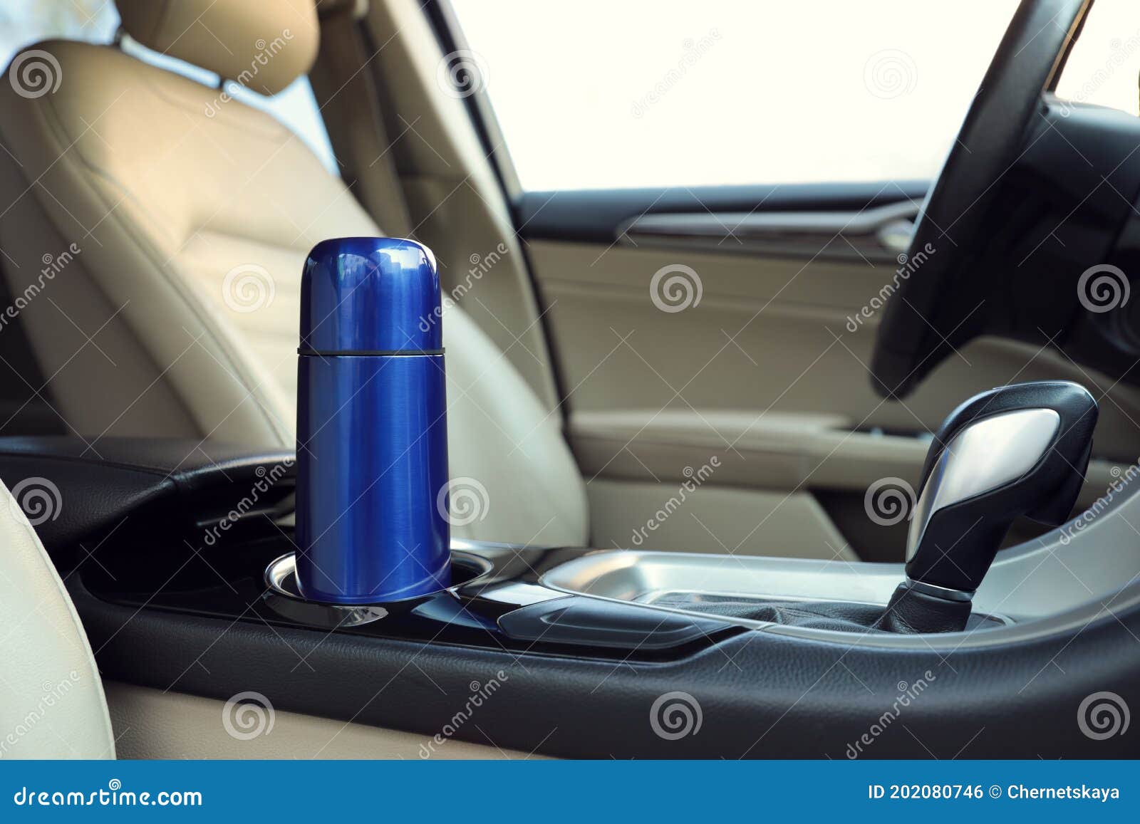 blue thermos in holder inside of car