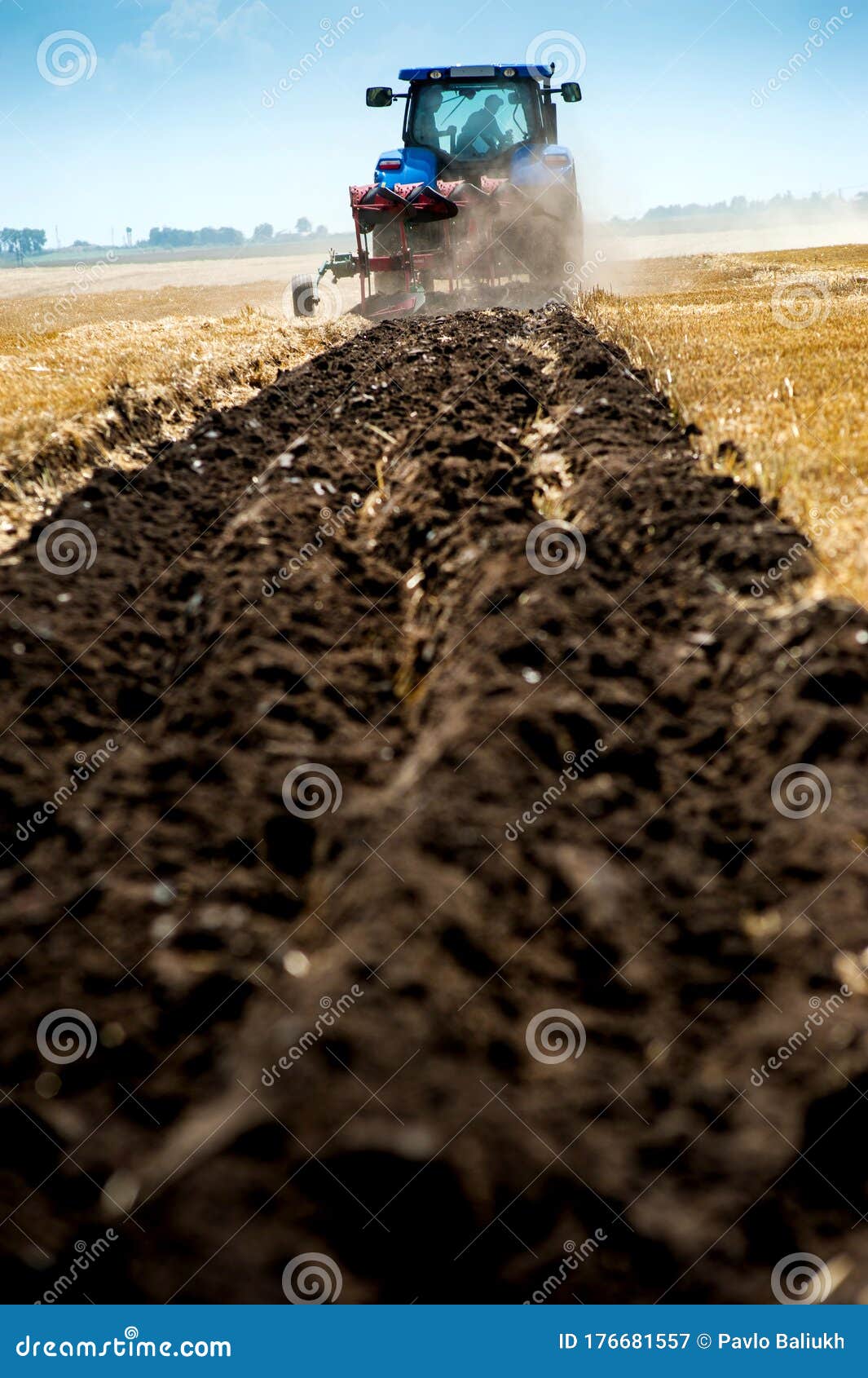 Blue Tractor Pulls Plow, Tillage Closeup in Focus, Agrarian Preparing