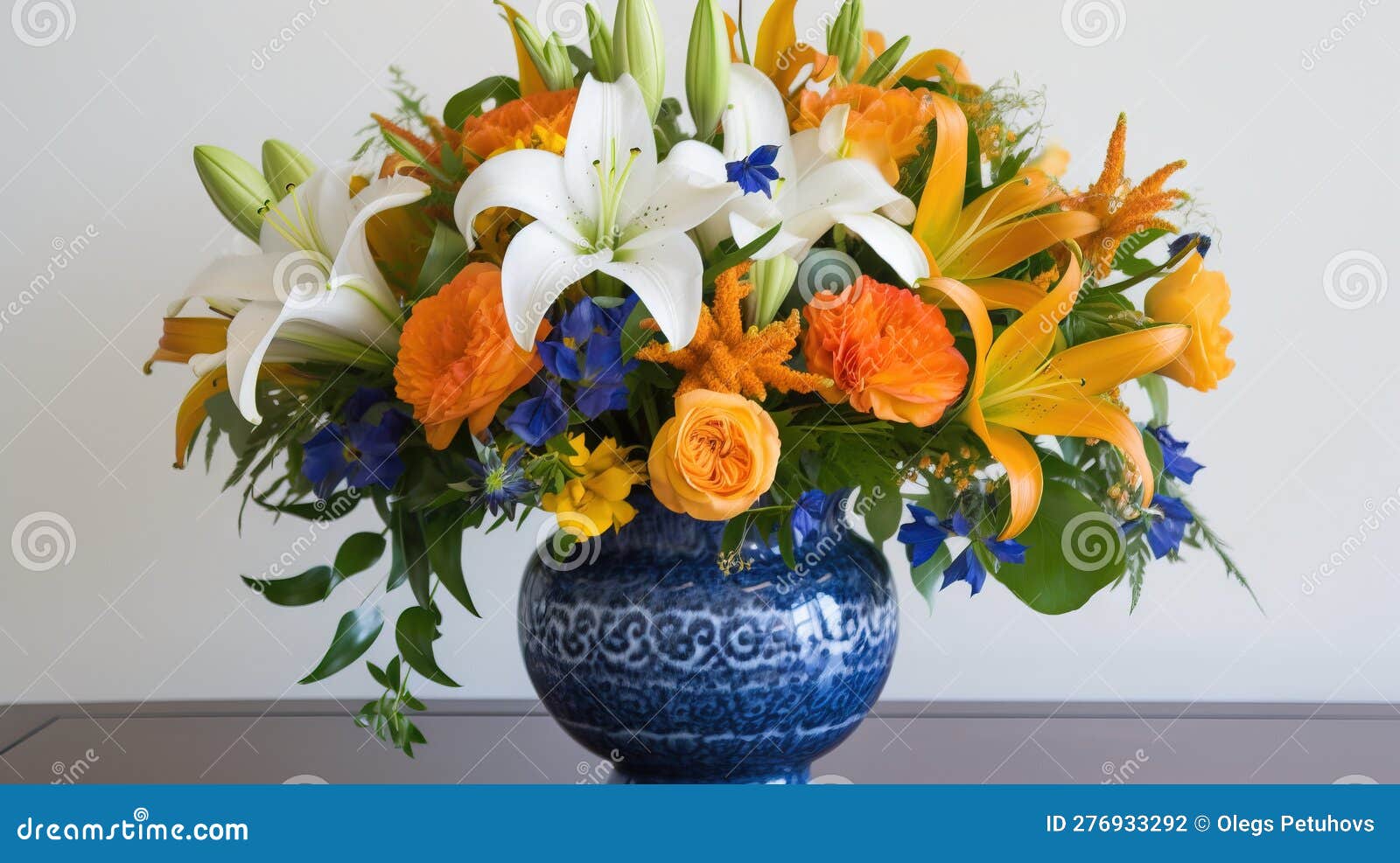 A Blue Vase with Orange and White Flowers in it on a Table with a White