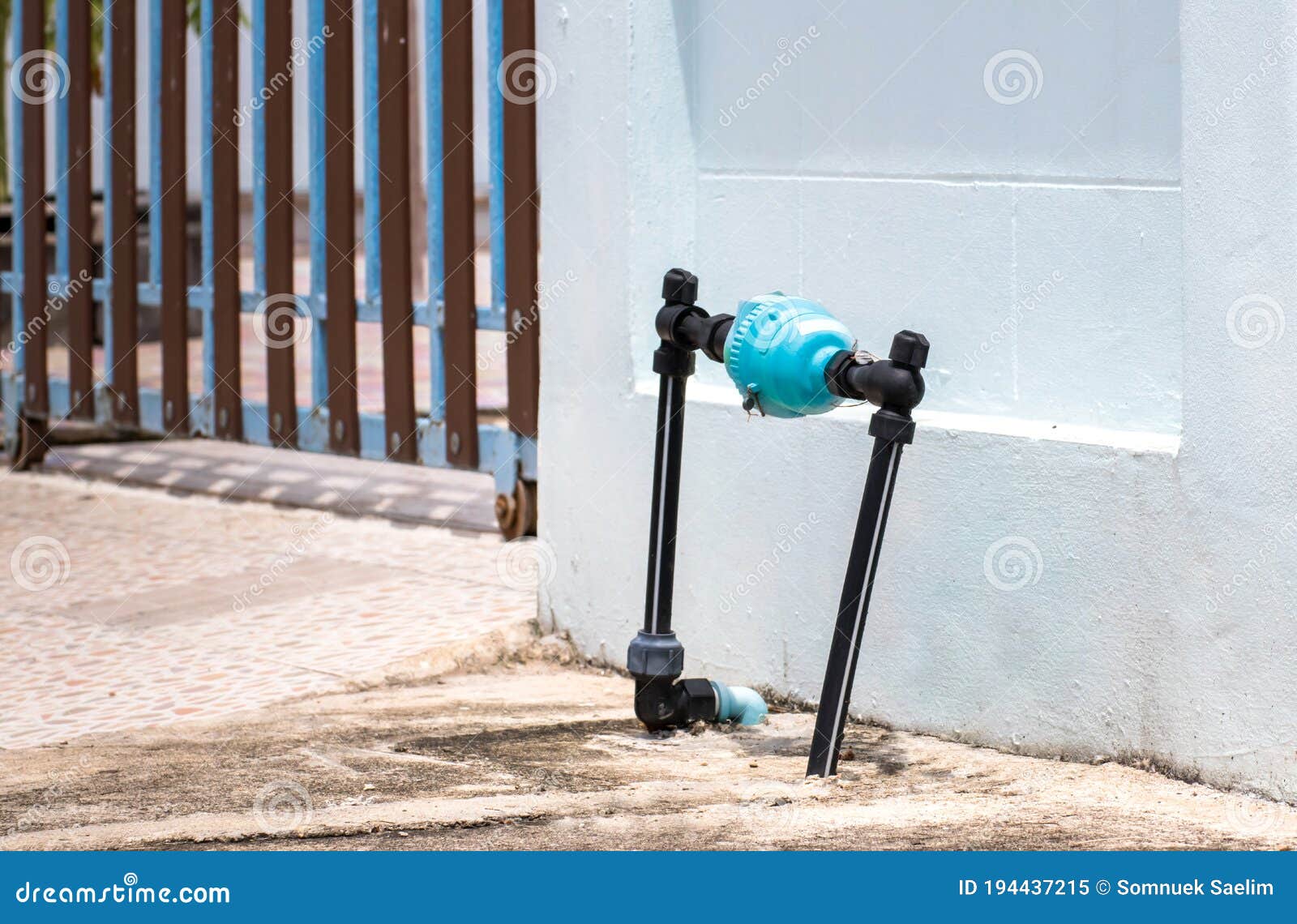 Blue Water Meter And Valve Supply Pipe With Joint And Hold On Front Water Meter On Side Of House