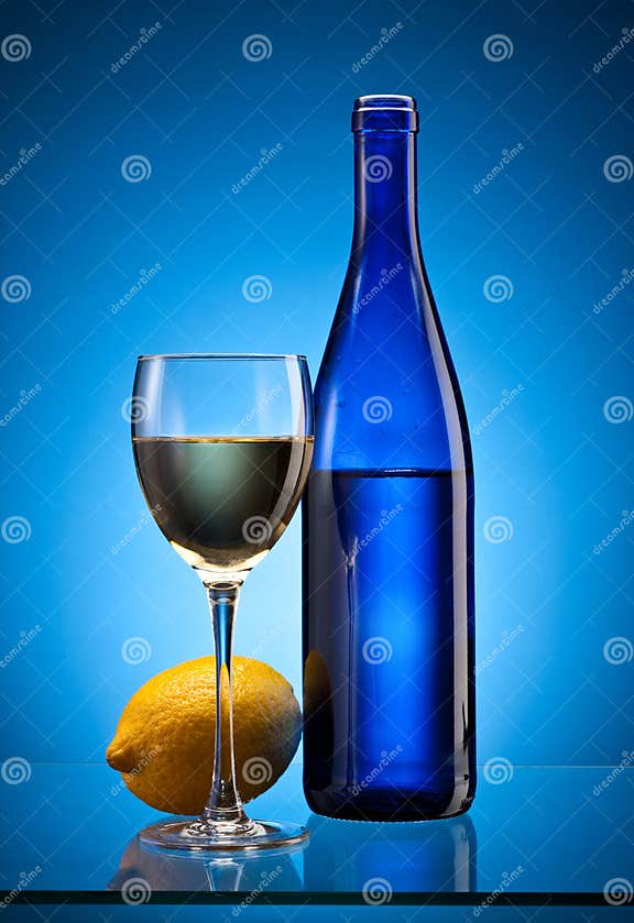 Blue wine bottle and lemon stock photo. Image of yellow 29269480