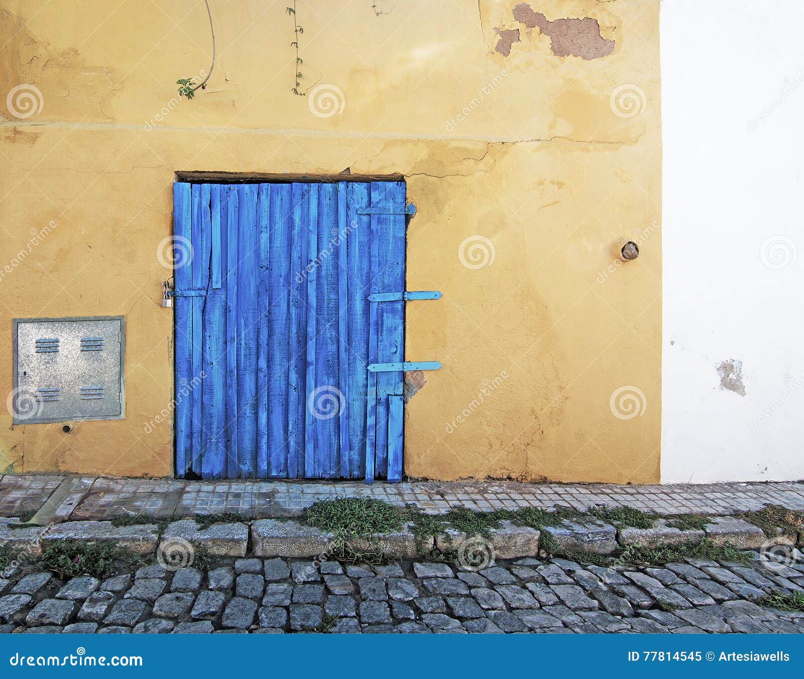 blue wood door on rustic yellow wall