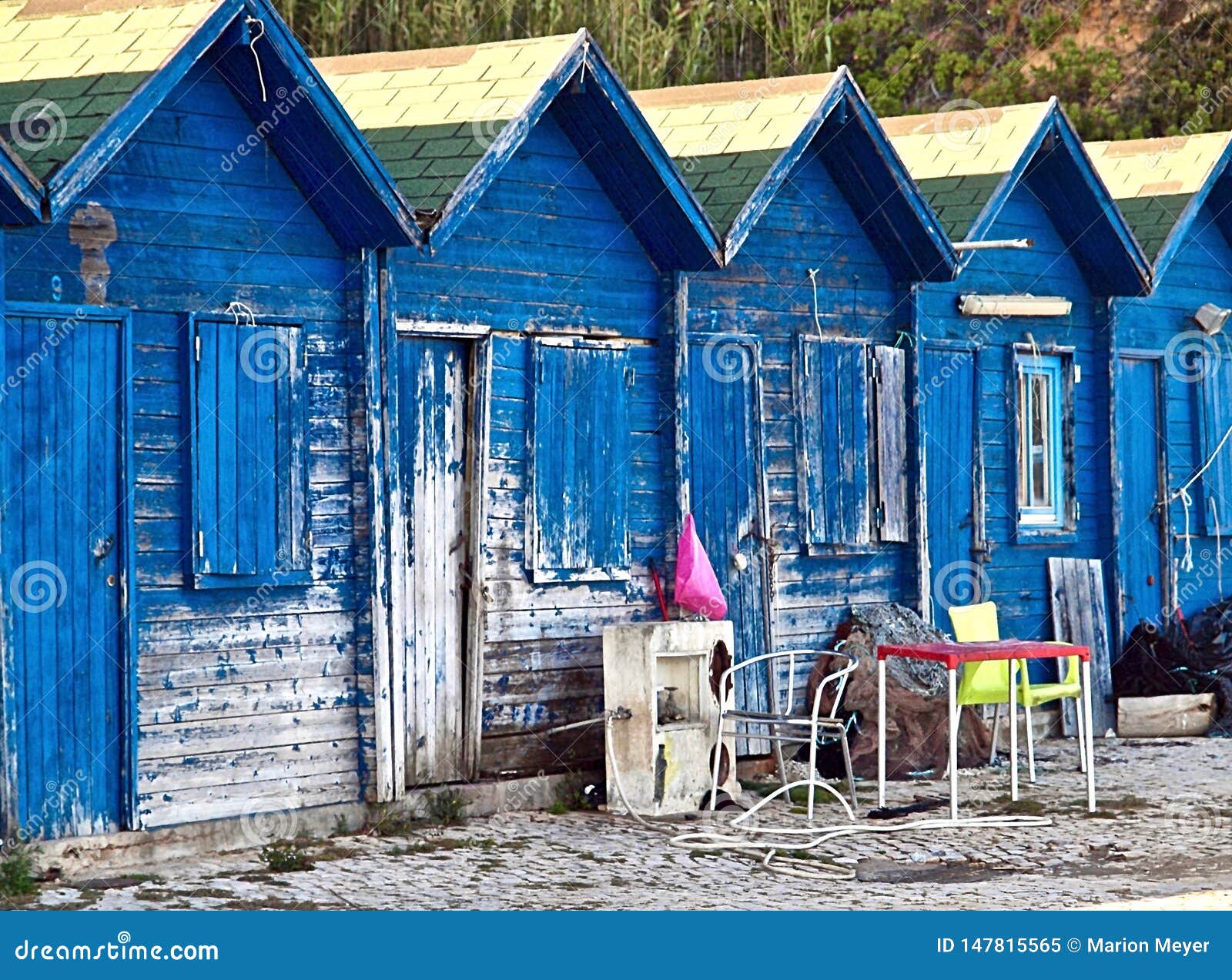 blue wooden fisher houses in olhos de agua in portugal