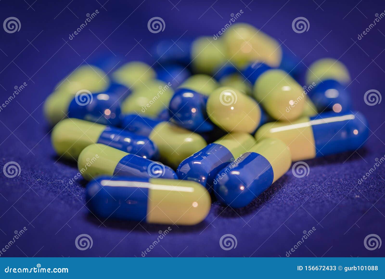 Blue and yellow capsules stock image. Image of enclose 156672433