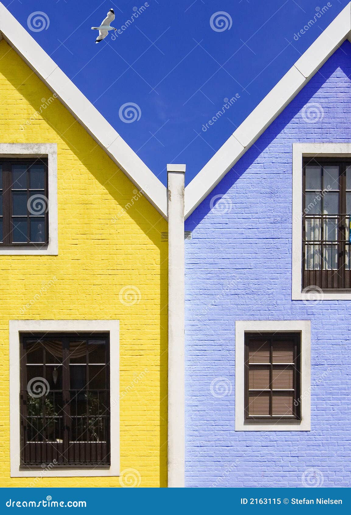 Blue and yellow houses stock image. Image of windows, yellow 2163115