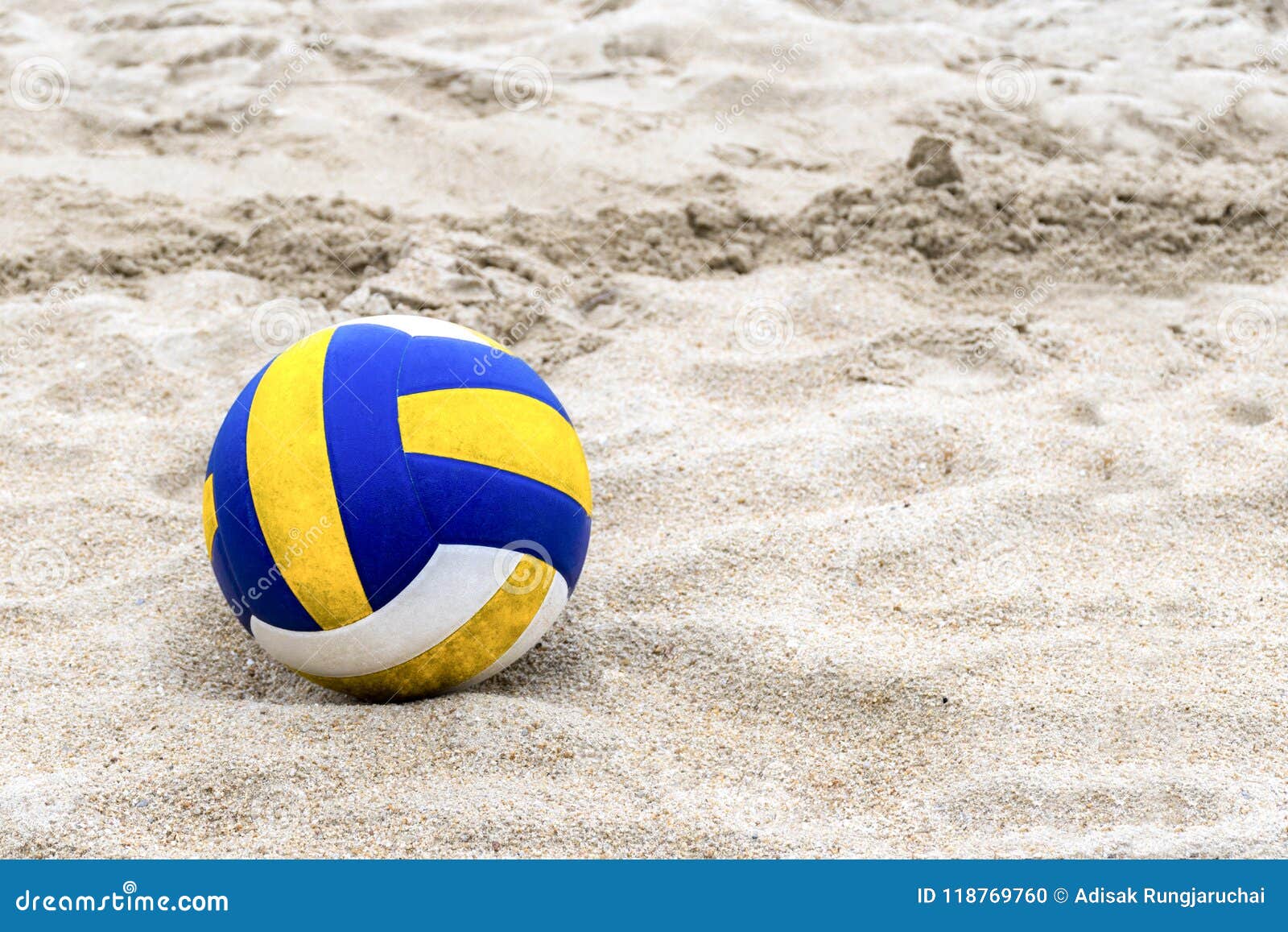 Blue and Yellow Volleyball on the Beach and Footprint on the Sands ...