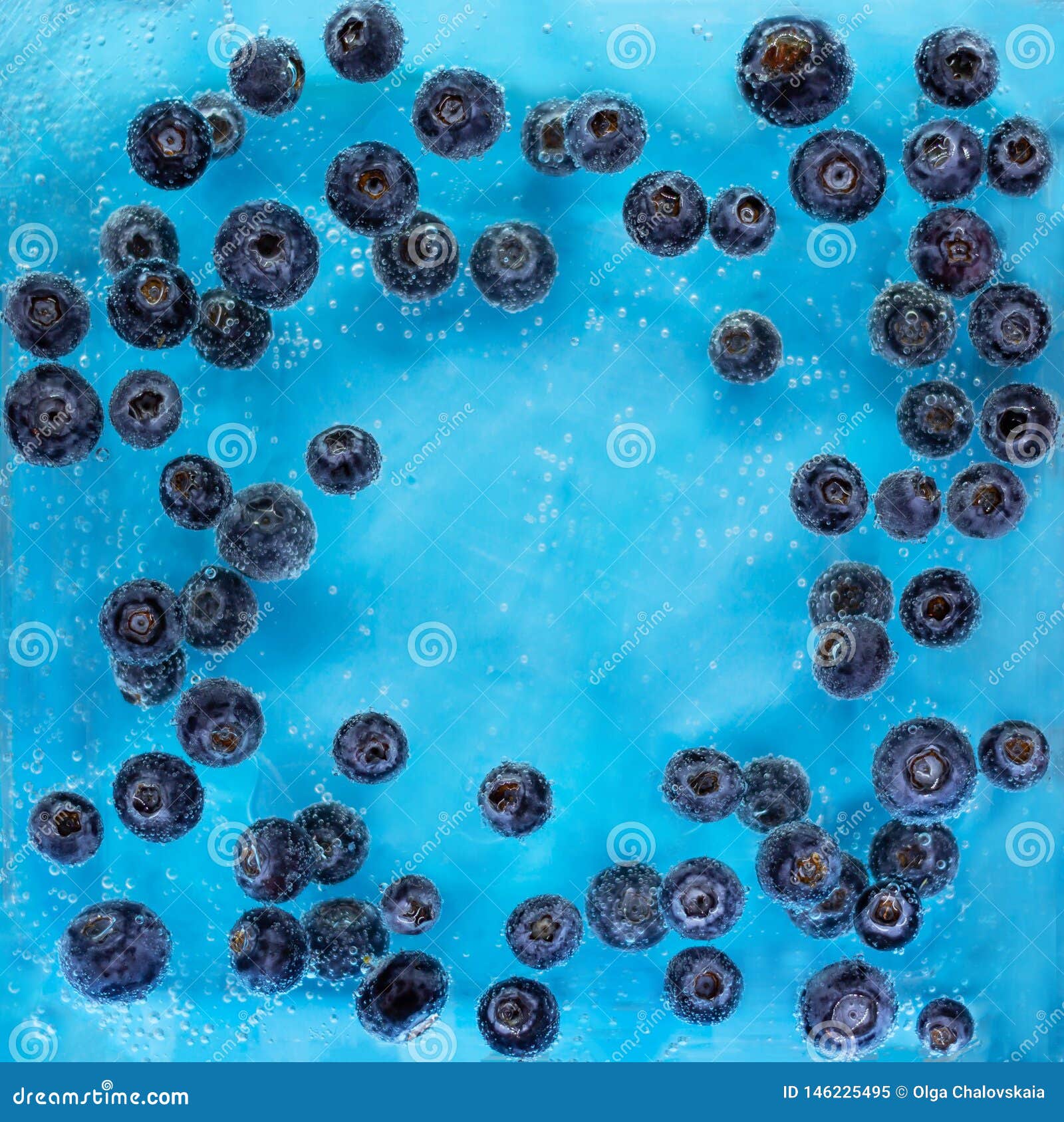 Blueberries Sinking into Blue Water with Air Bubbles Background Stock
