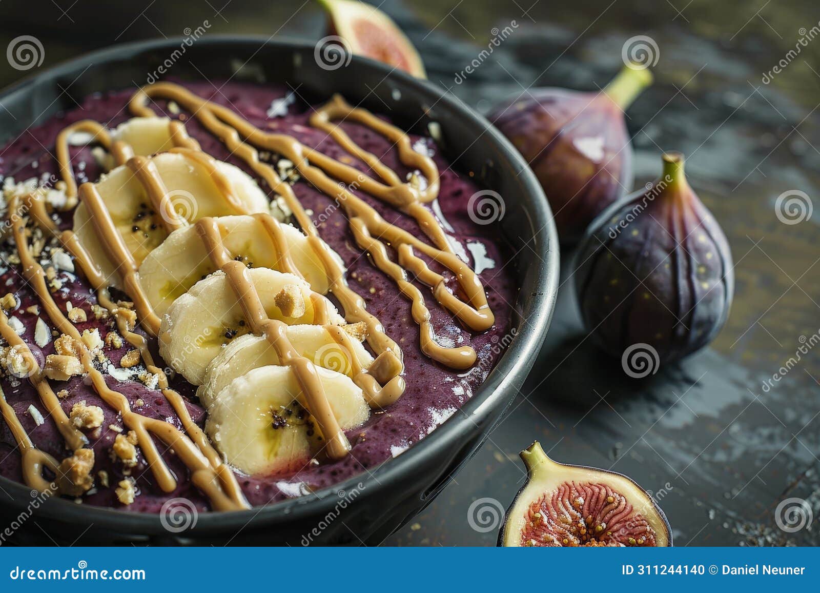 a blueberry smoothie bowl with bananas, nut butter and figues