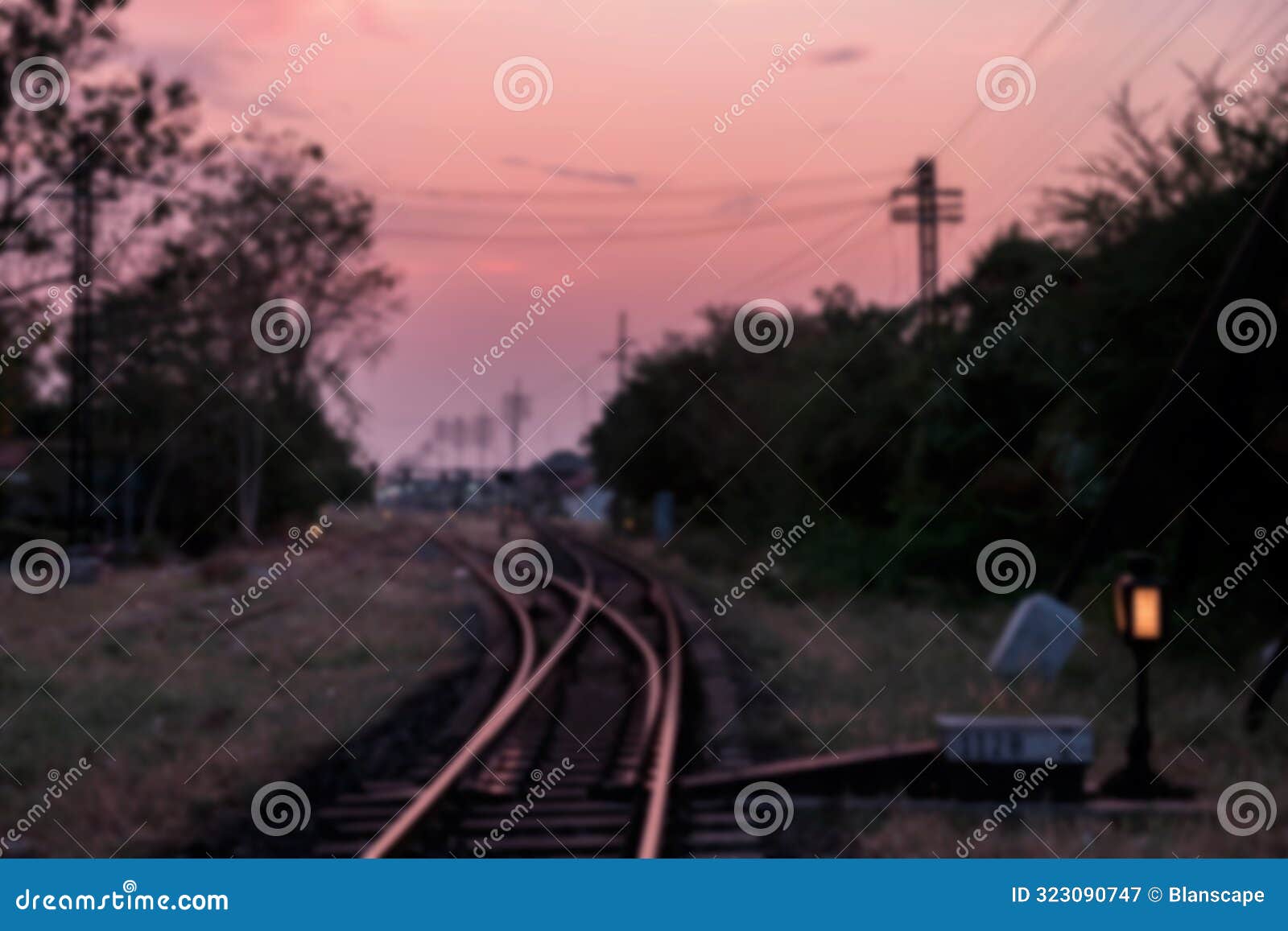 blur image of railway at dusk with twilight sky in korat, thailand