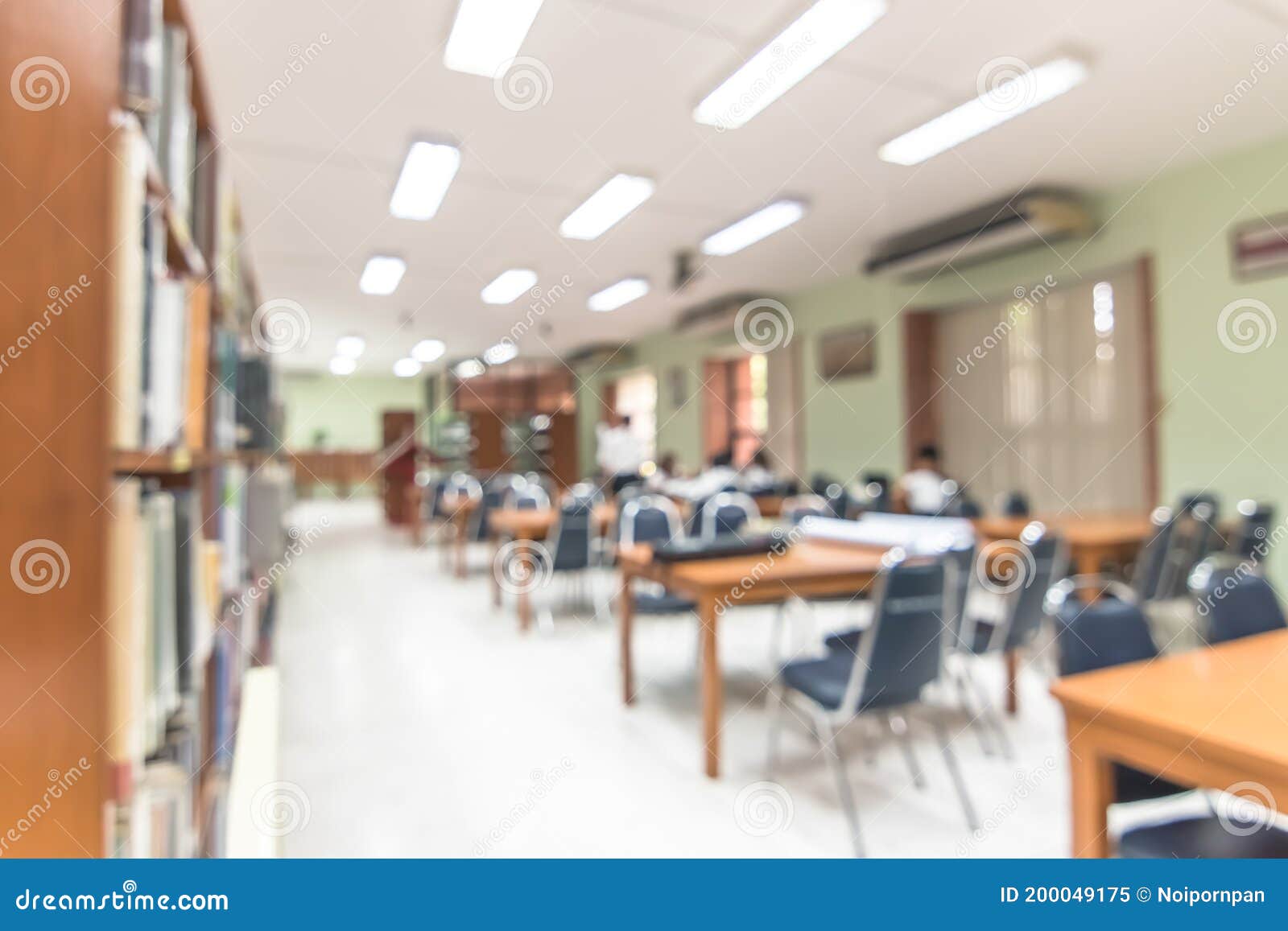 Blur School Library with Book Shelves, Tables and Chairs for Education Background Stock Image