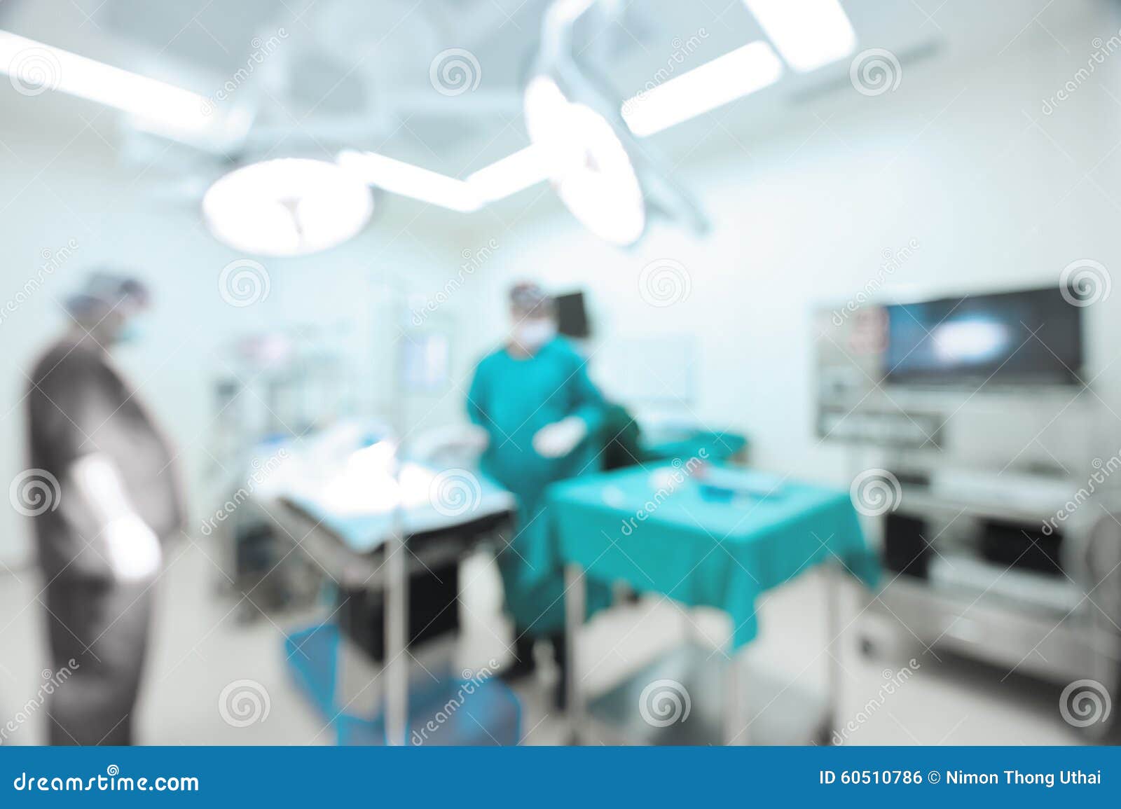 blur of two veterinarian surgeons in operating room