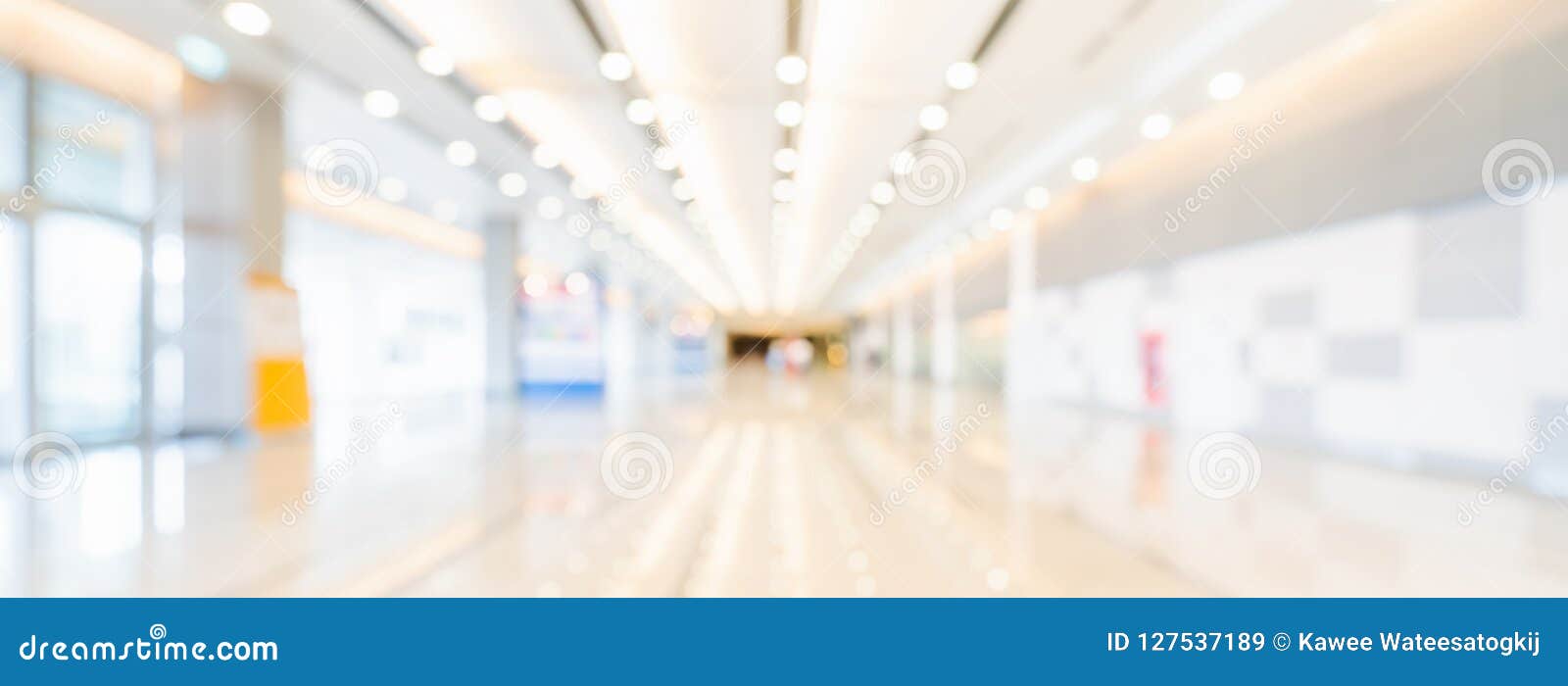 blurred bokeh panoramic banner background of exhibition hall or convention center hallway. business trade show event