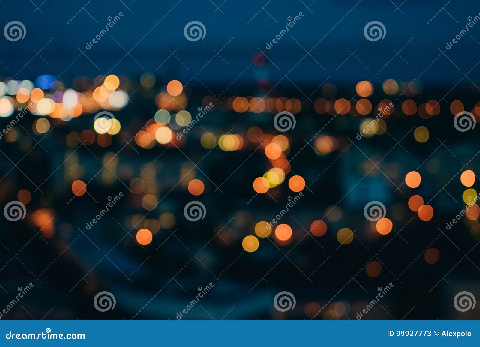 blurred city lights against dark evening sky