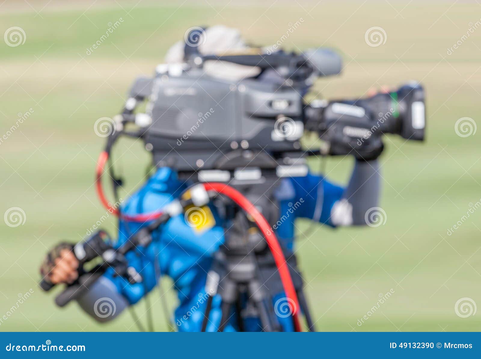 blurred image of a man is recording vdo during golf tournament.