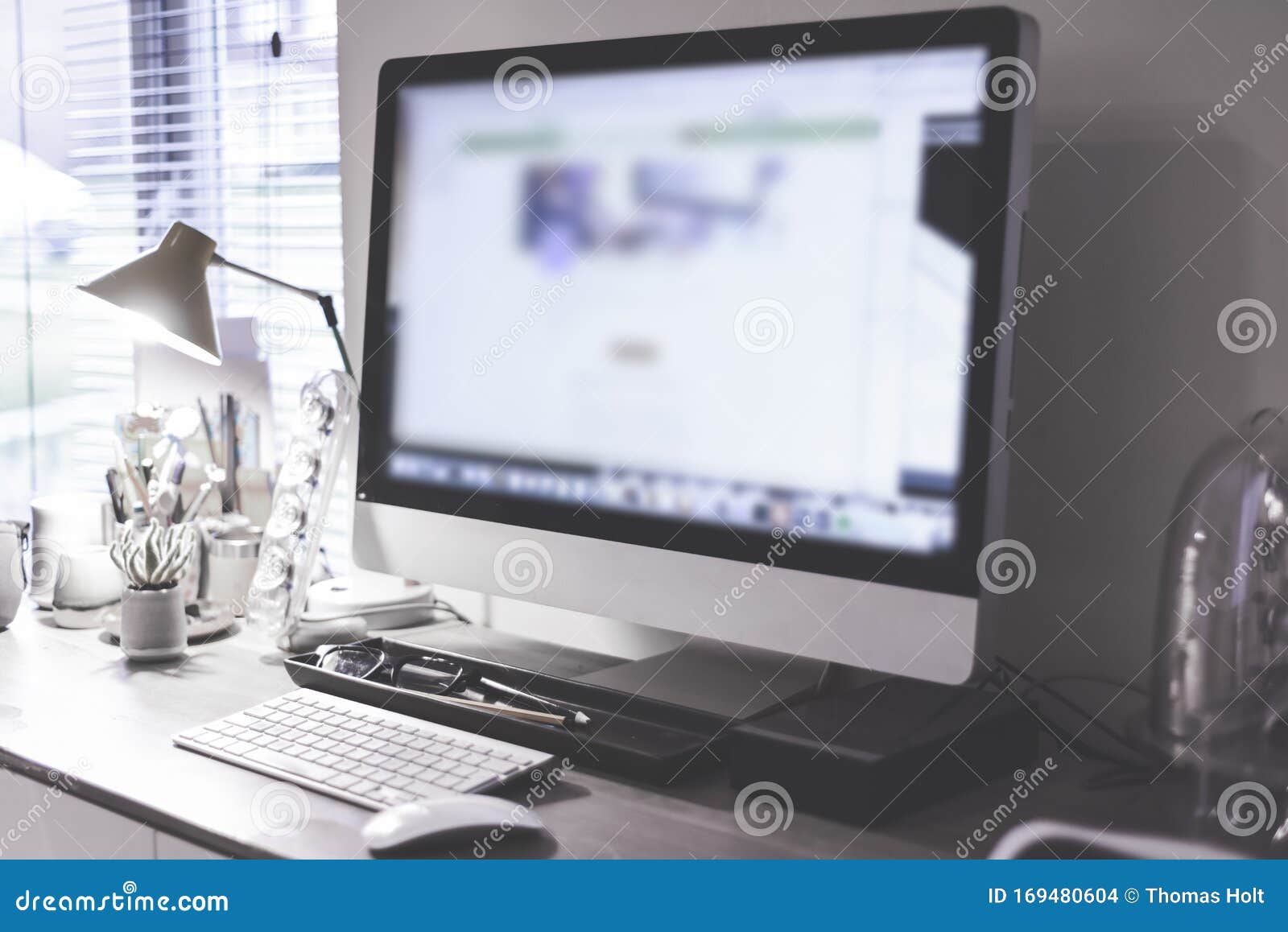 Blurred Large Computer Screen on a Home Office Desk Interior Eith Work