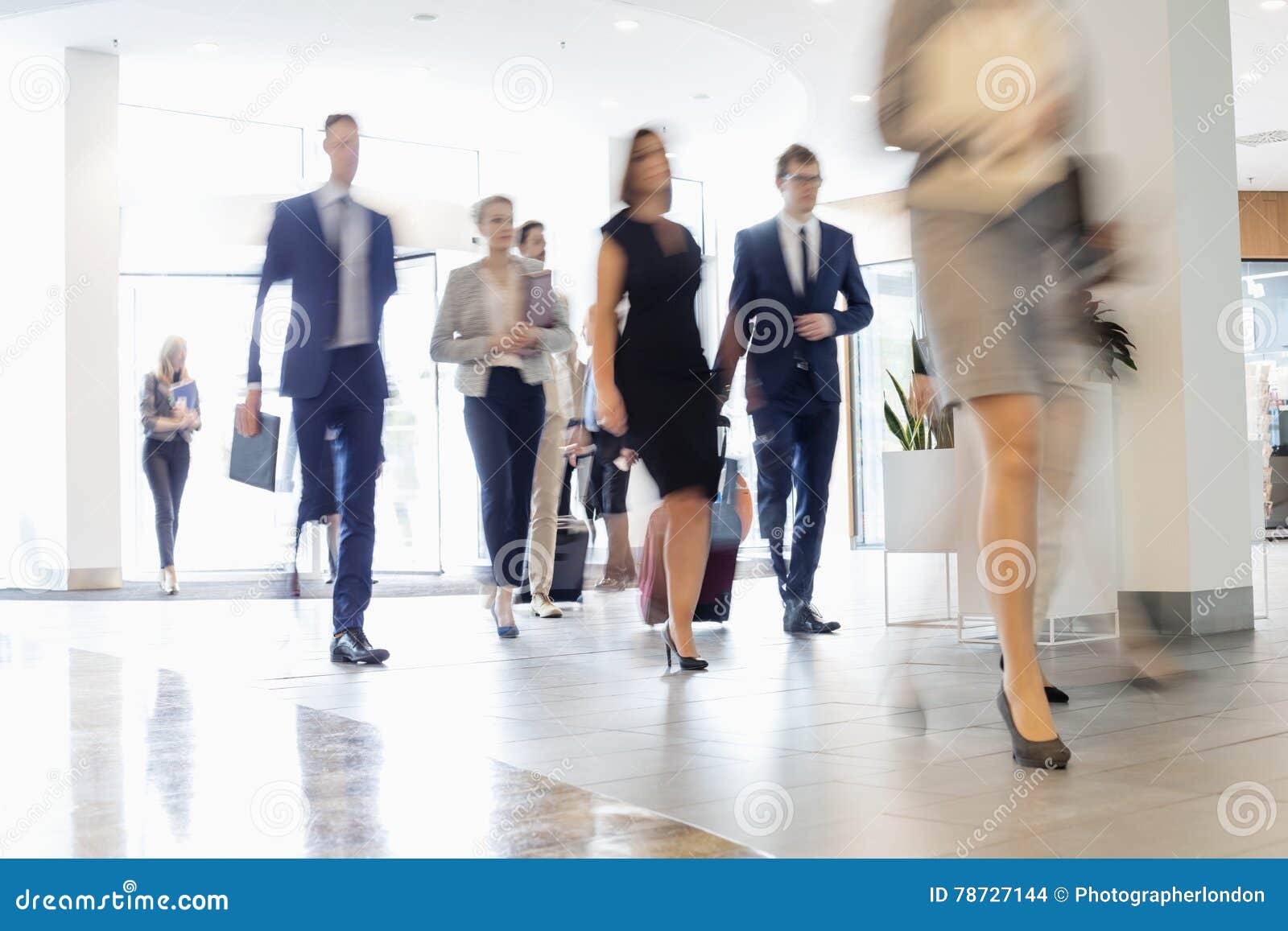 blurred motion of business people walking at convention center