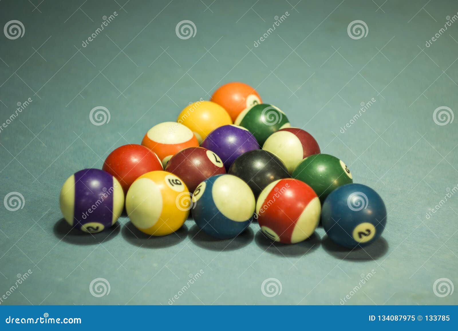A Blurred Multicolored Billiard Balls with Numbers on a Blue Cloth