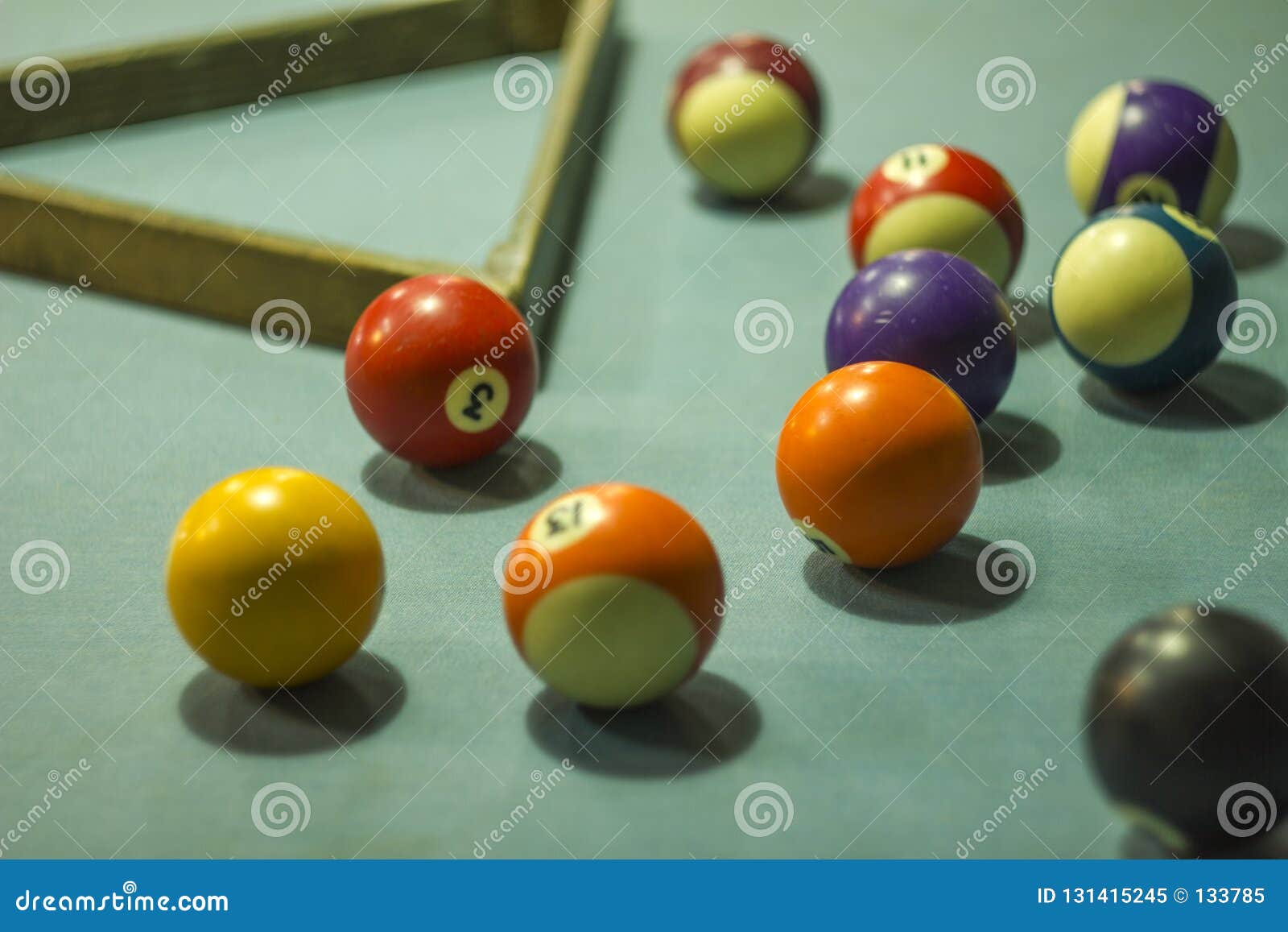 A Blurred Multicolored Billiard Balls on a Blue Table Cloth with