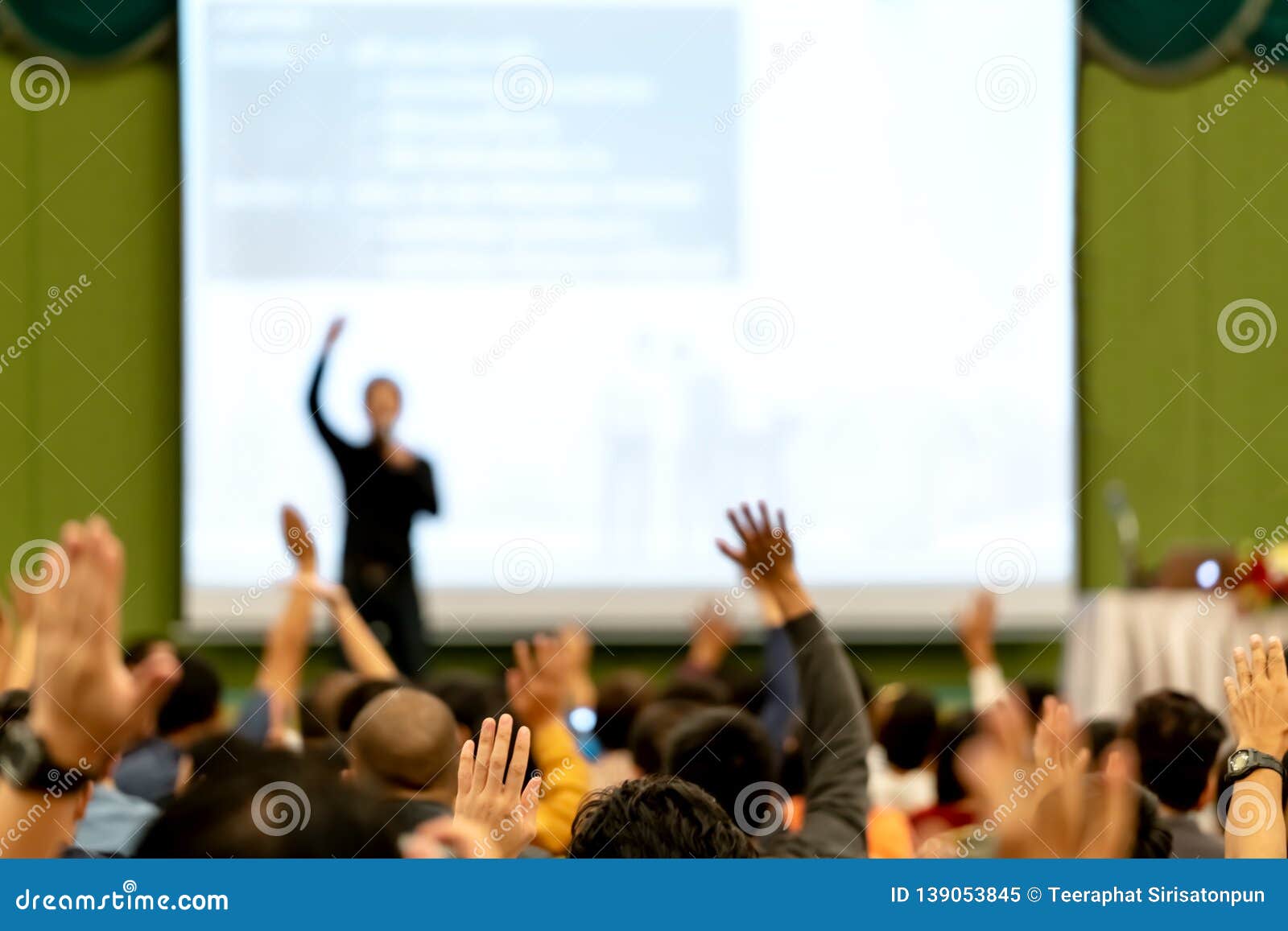 blurred of rear view audience in conference hall or seminar room. speaker are brainstorming, motivational speech at